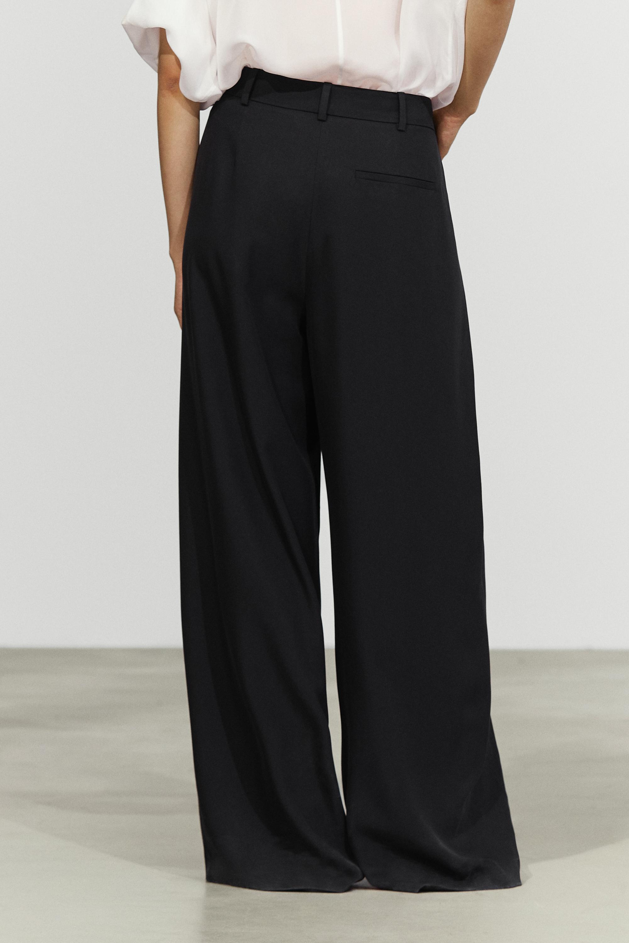 Flowing pleated pants with button detail — BLACK