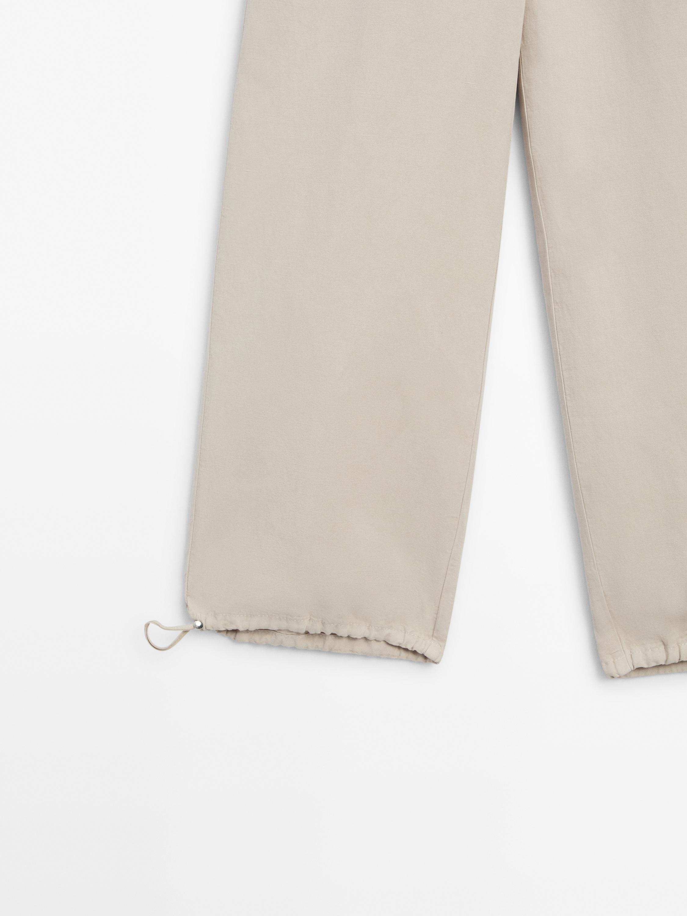 Trousers with elasticated waistband and adjustable hems