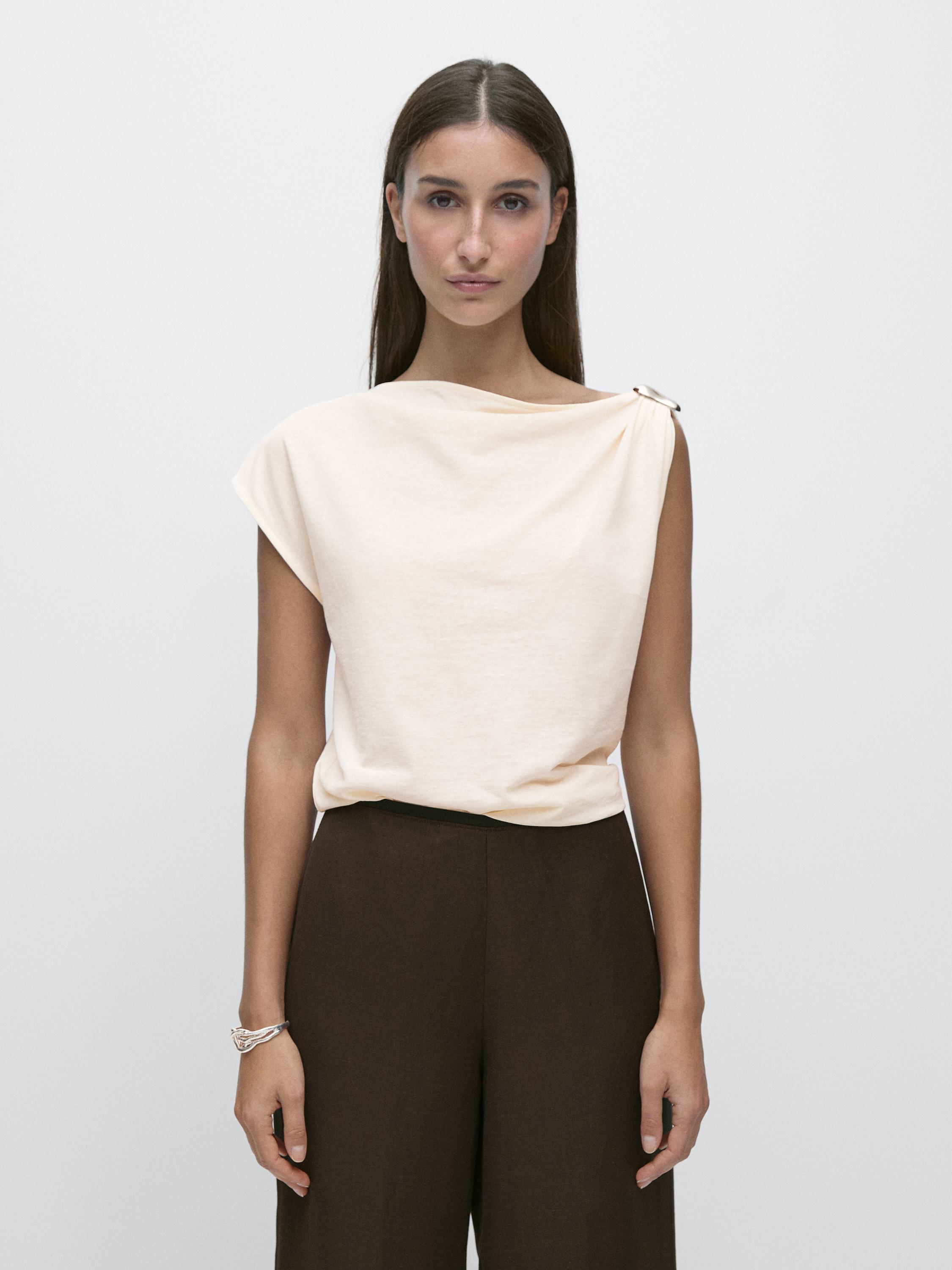 Asymmetric top with shoulder appliqué