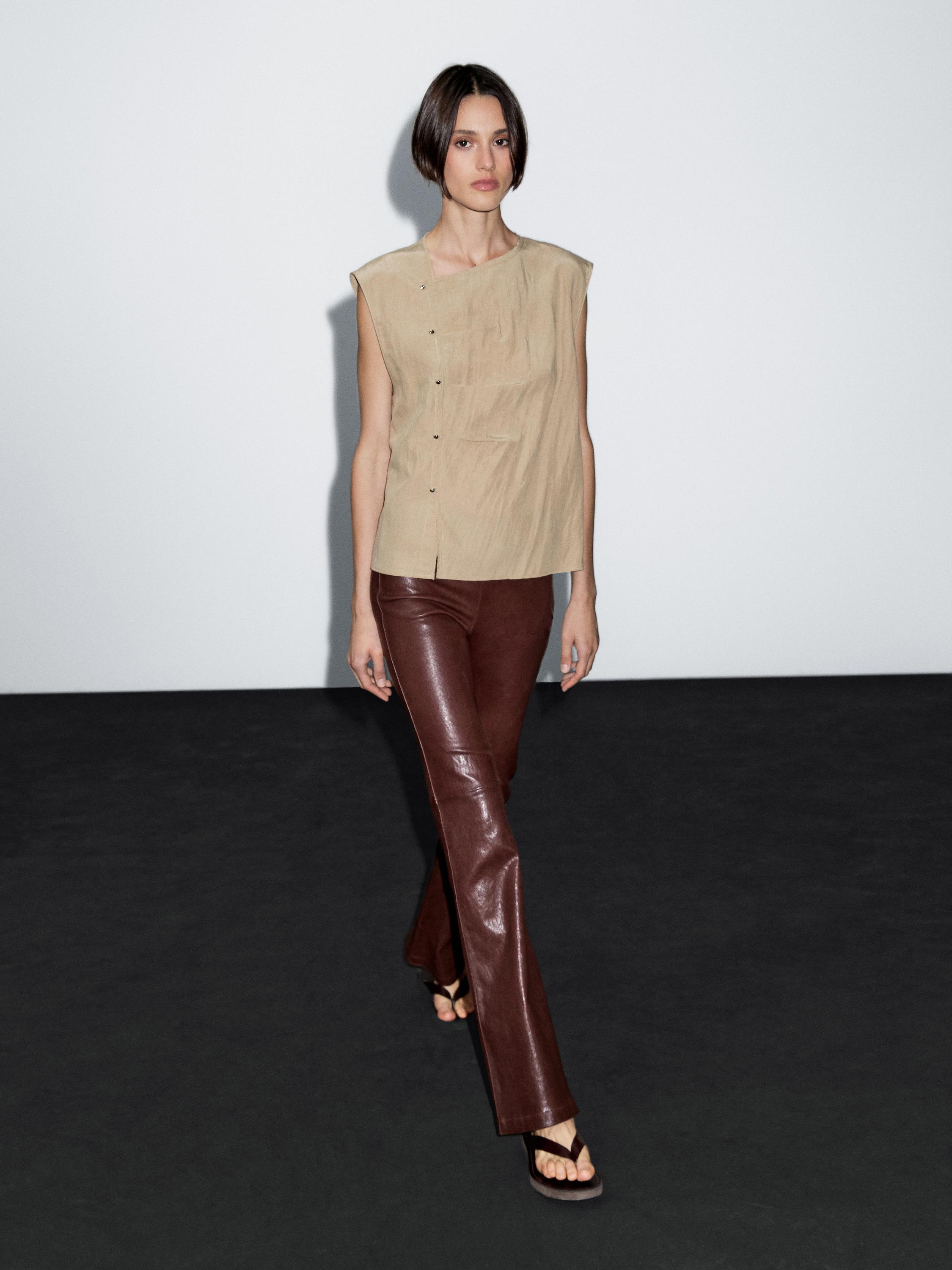 Blouse with silver button fastening on the side