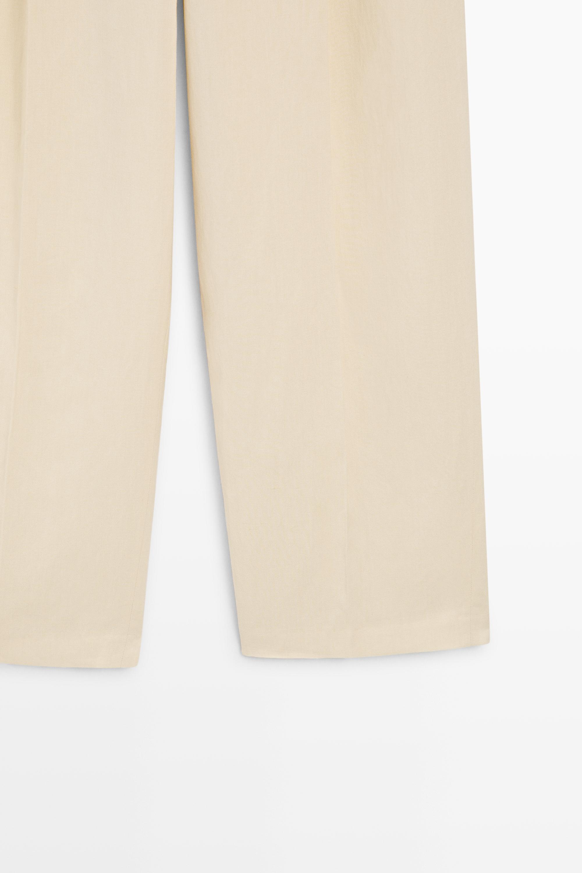 Flowing trousers with pleats — Beige
