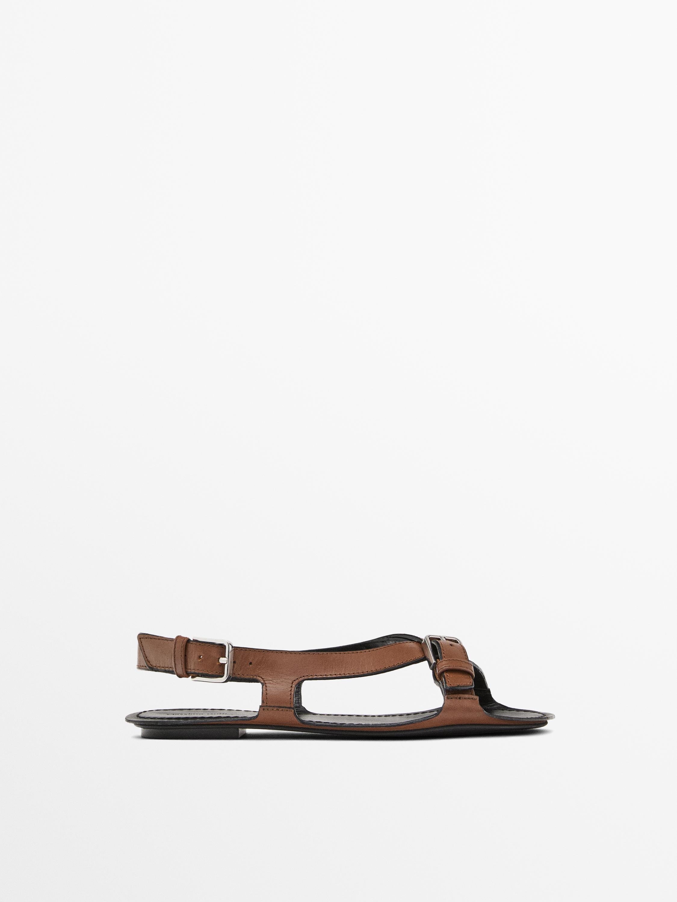 Flat leather sandals with buckles