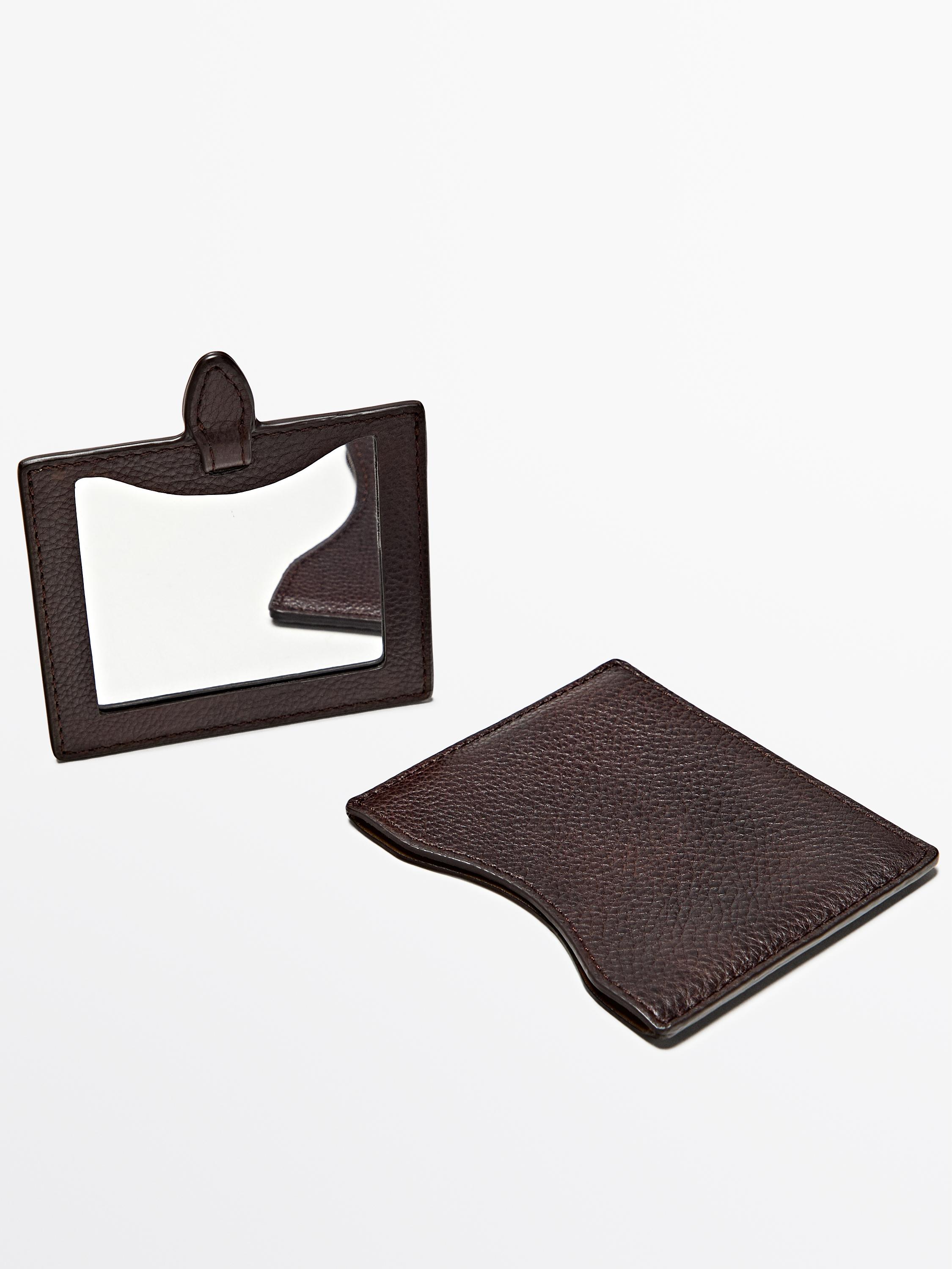 Front view of chocolate coin purse with detachable mirror.