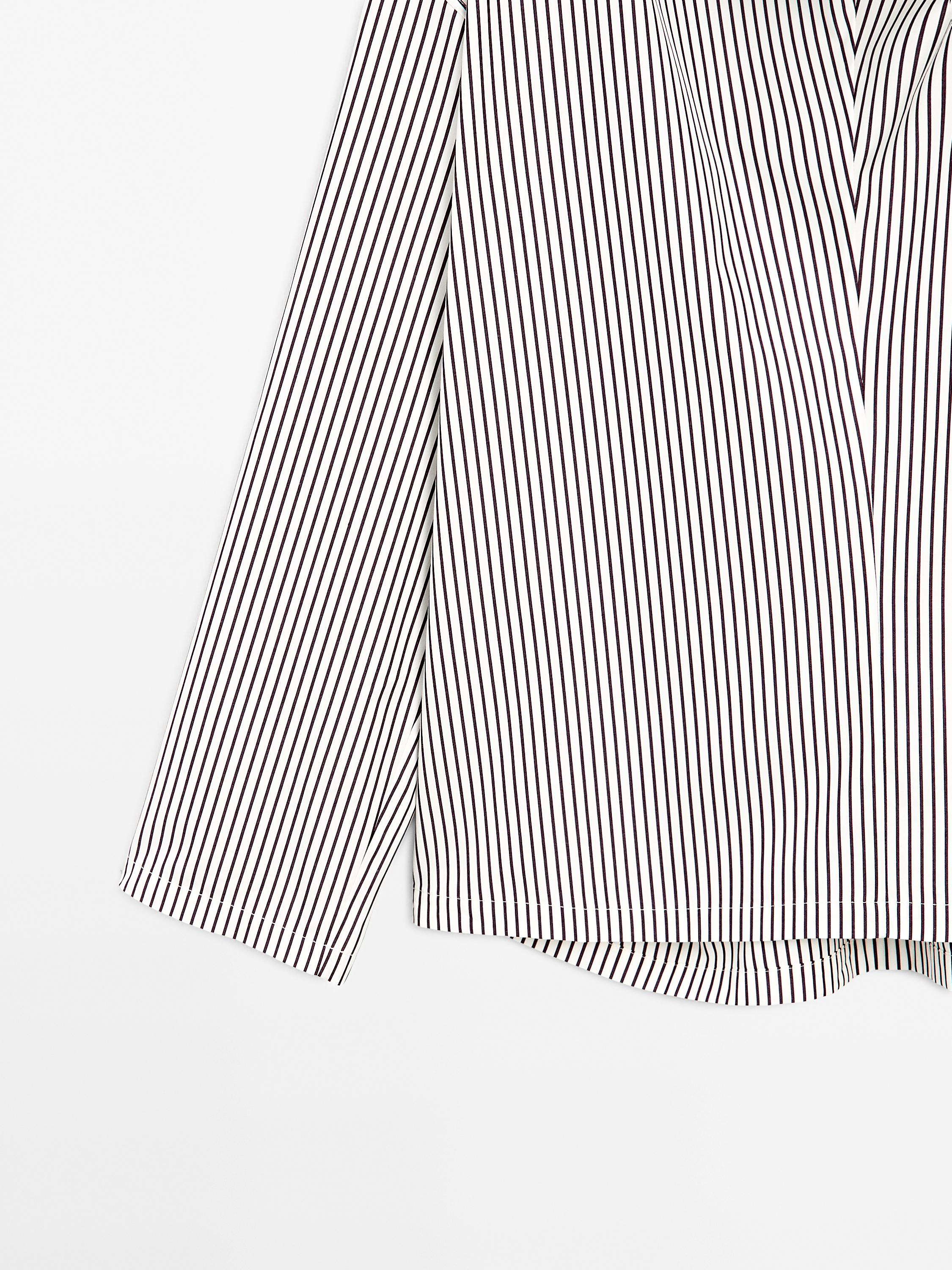 Blouse with neckline drawstring and appliqué