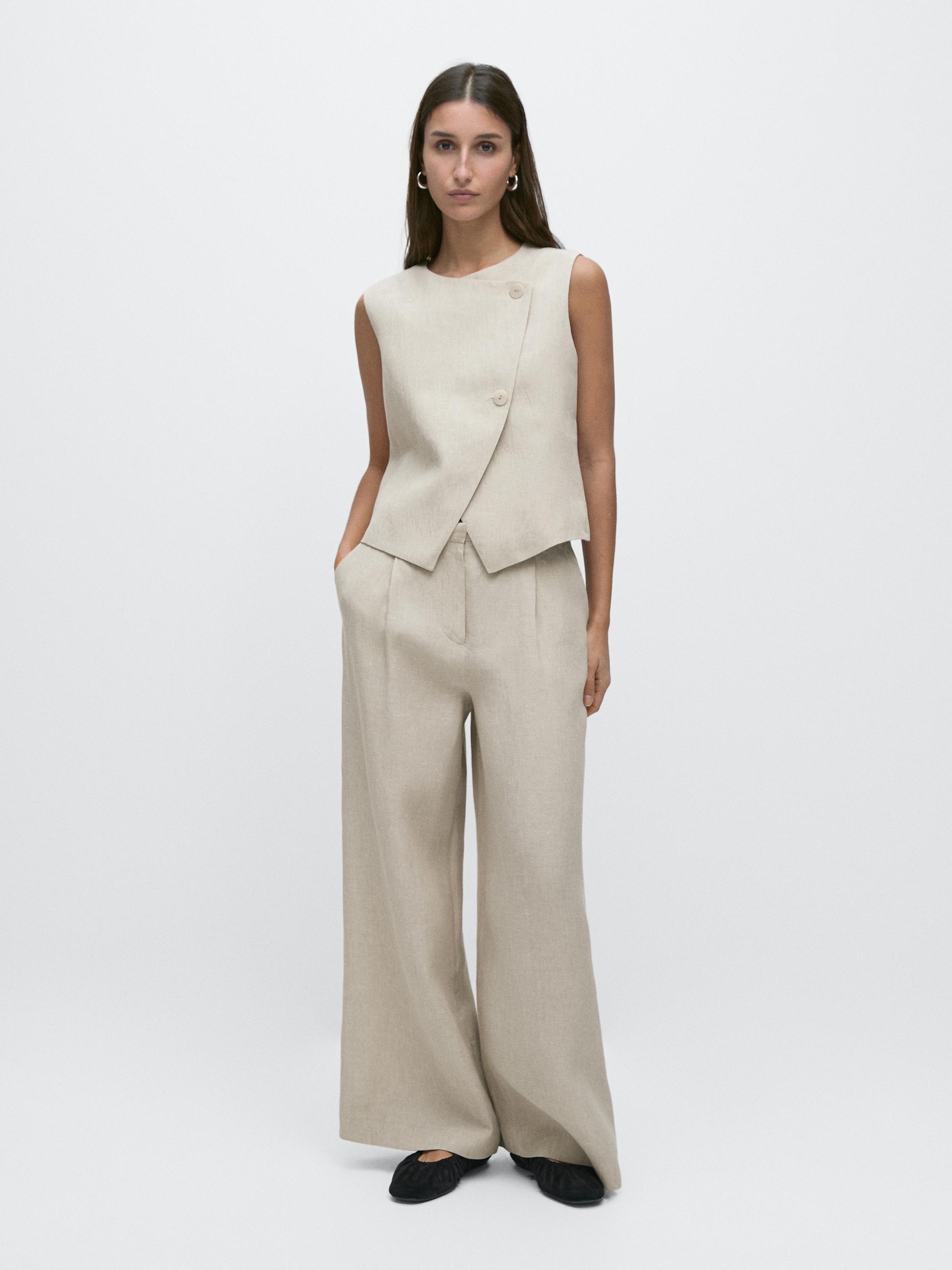 Stone vest set with side buttons and matching wide-leg pants, visible side pockets.