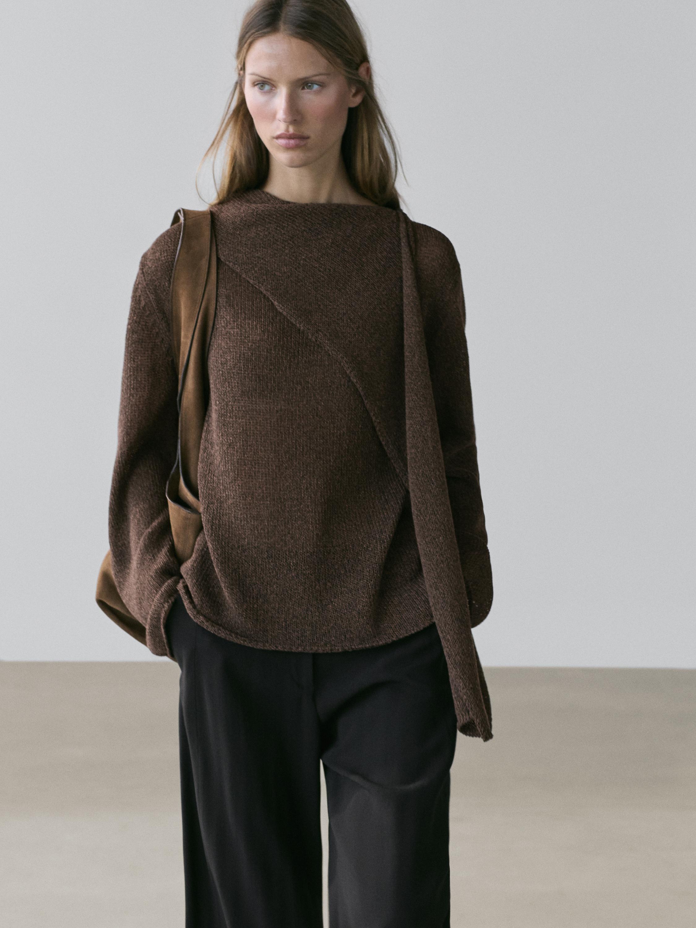 Chocolate brown sweater set with crossover design and black pants.