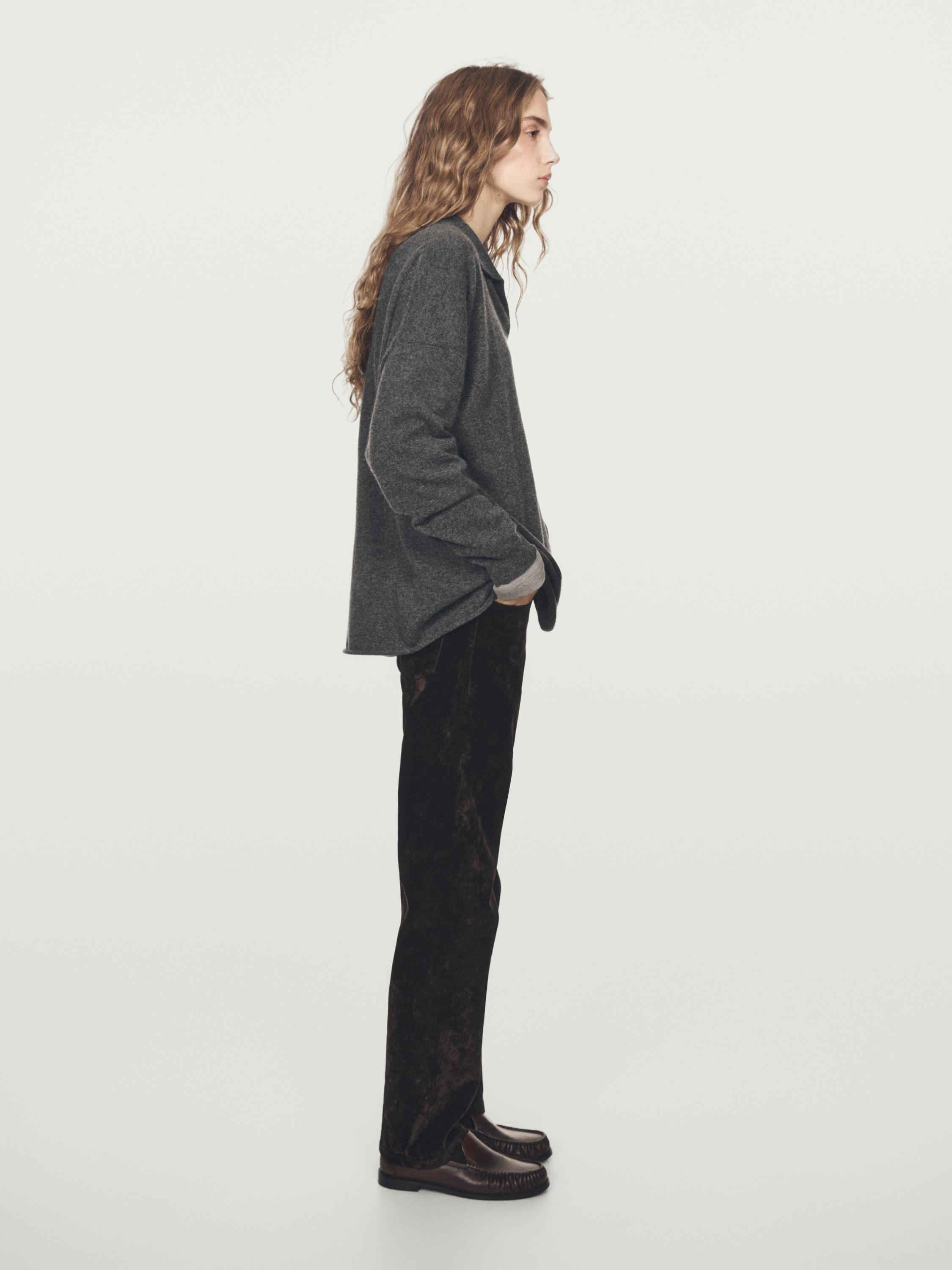 Oversized medium gray sweater and dark pants set, side view.