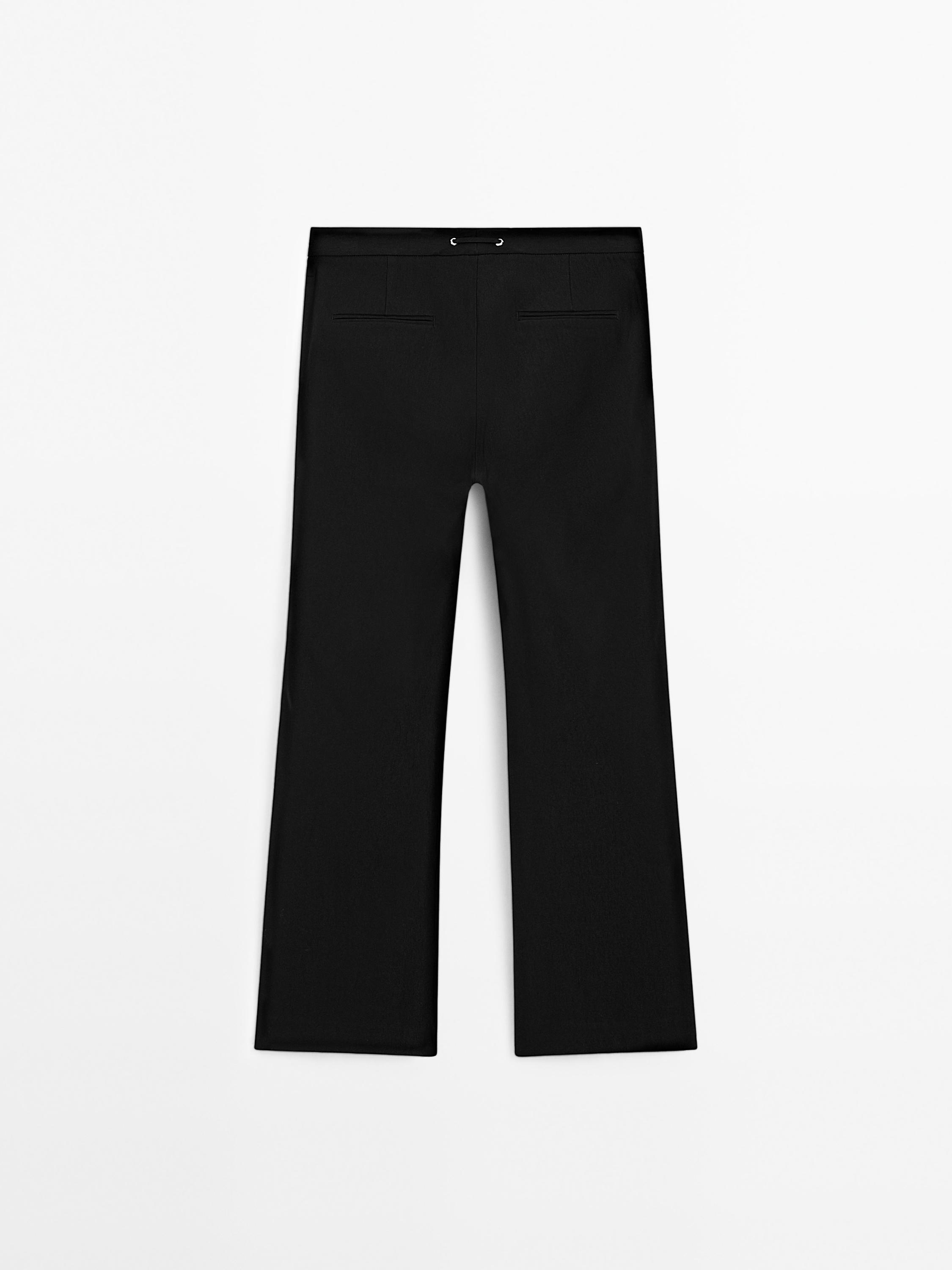 Flared trousers with waist detail