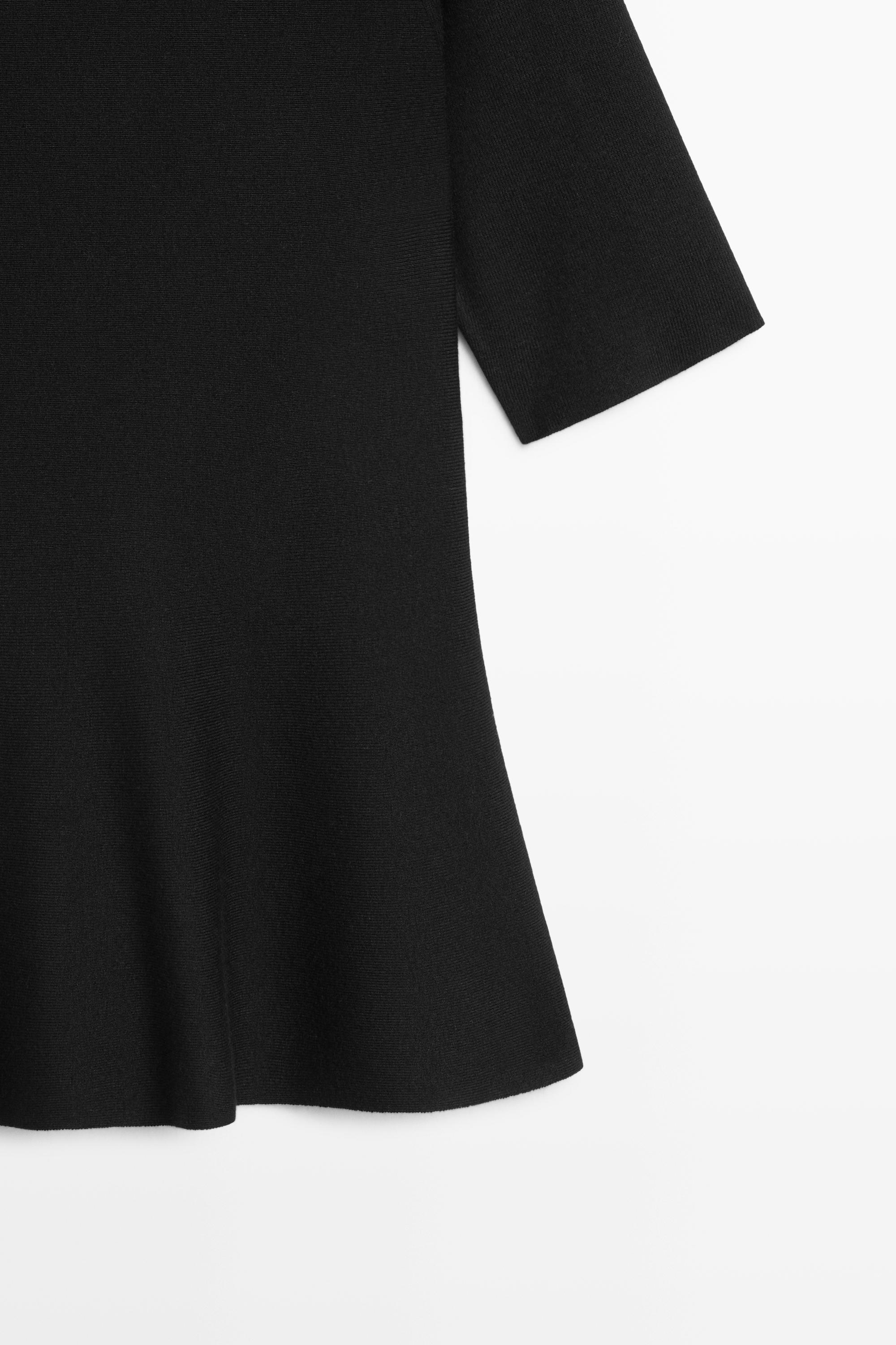 Peplum detail knit top — BLACK