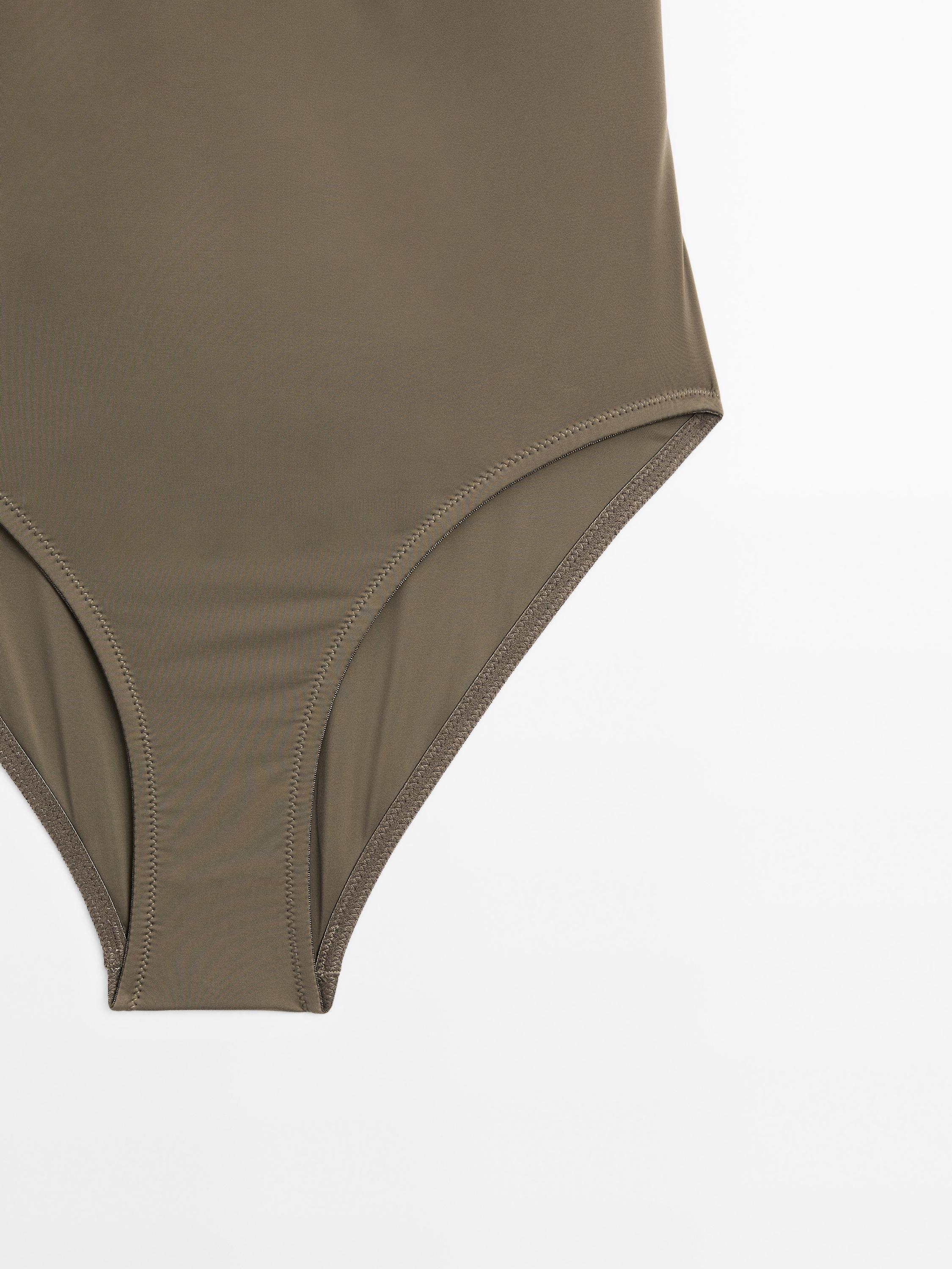 Bandeau swimsuit with metal piece detail