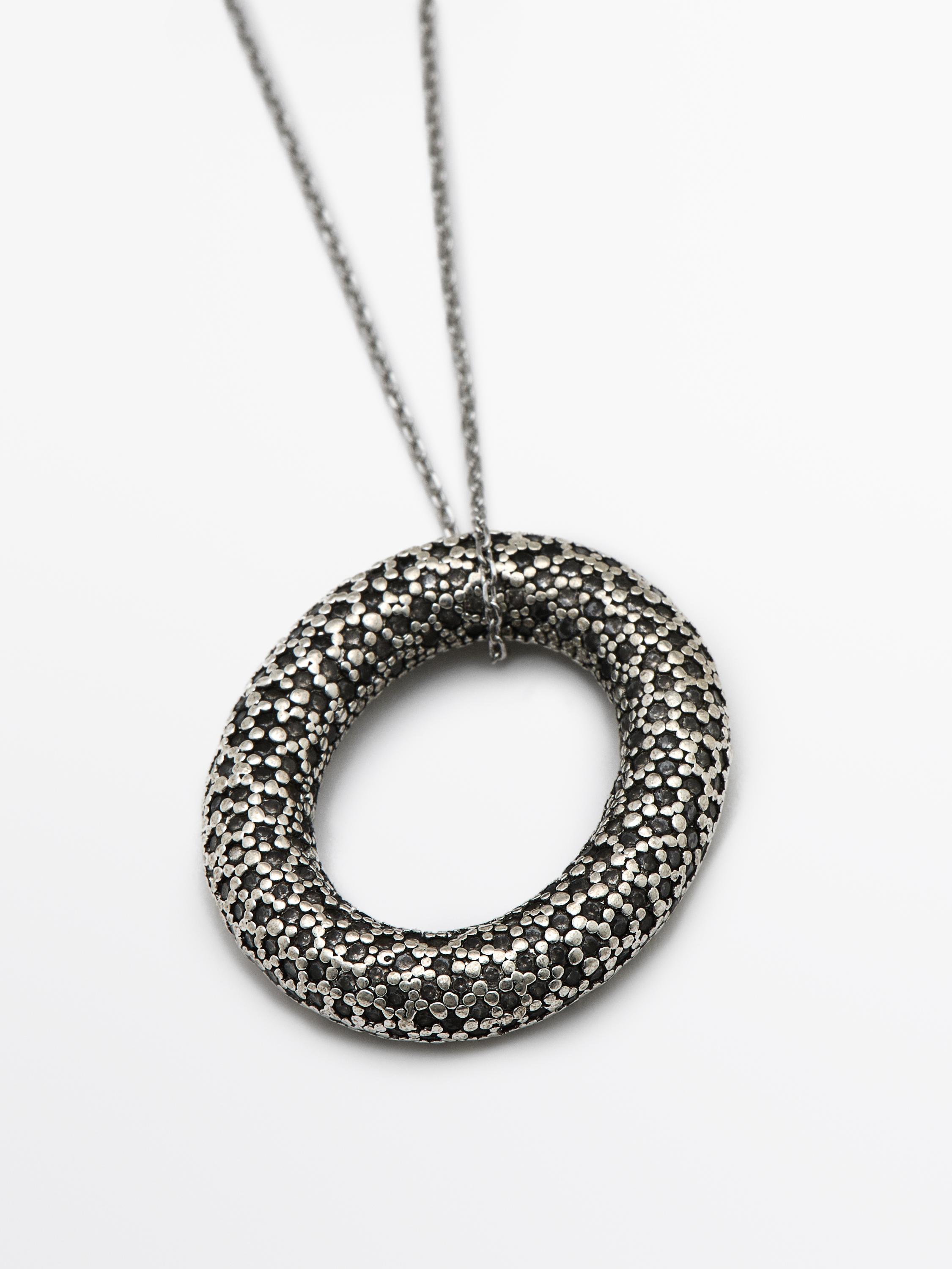 Necklace with rhinestone textured piece