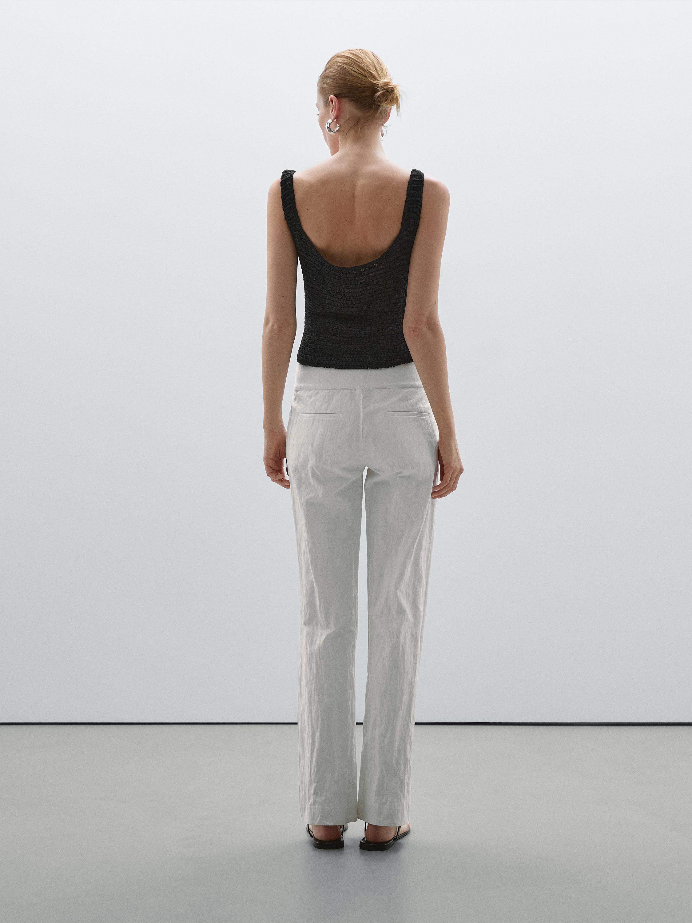 Slim fit low-rise trousers with buckles