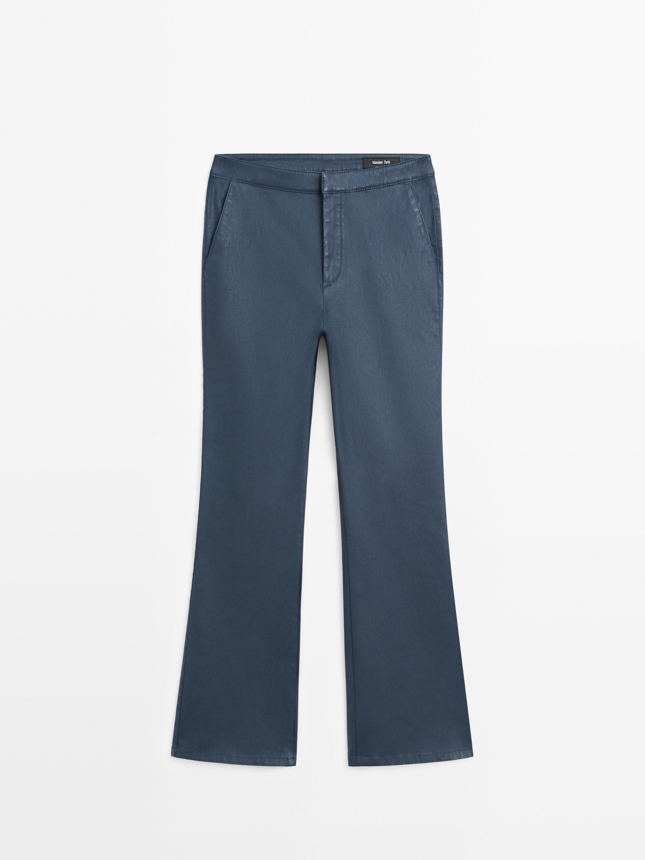 Front view of cropped flare fit blue pants with side pockets and front closure.