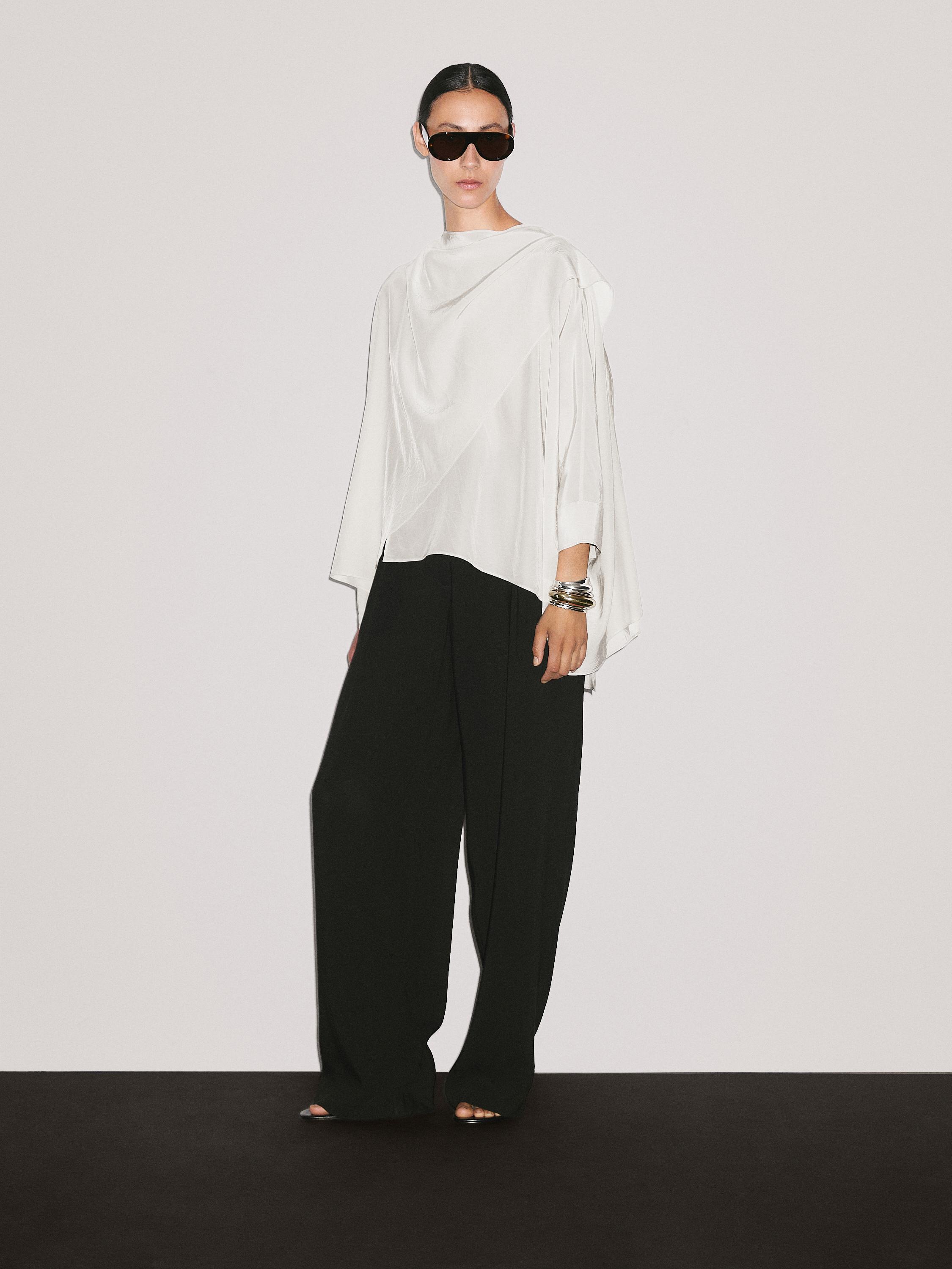 Short flowing cape with sleeve detail