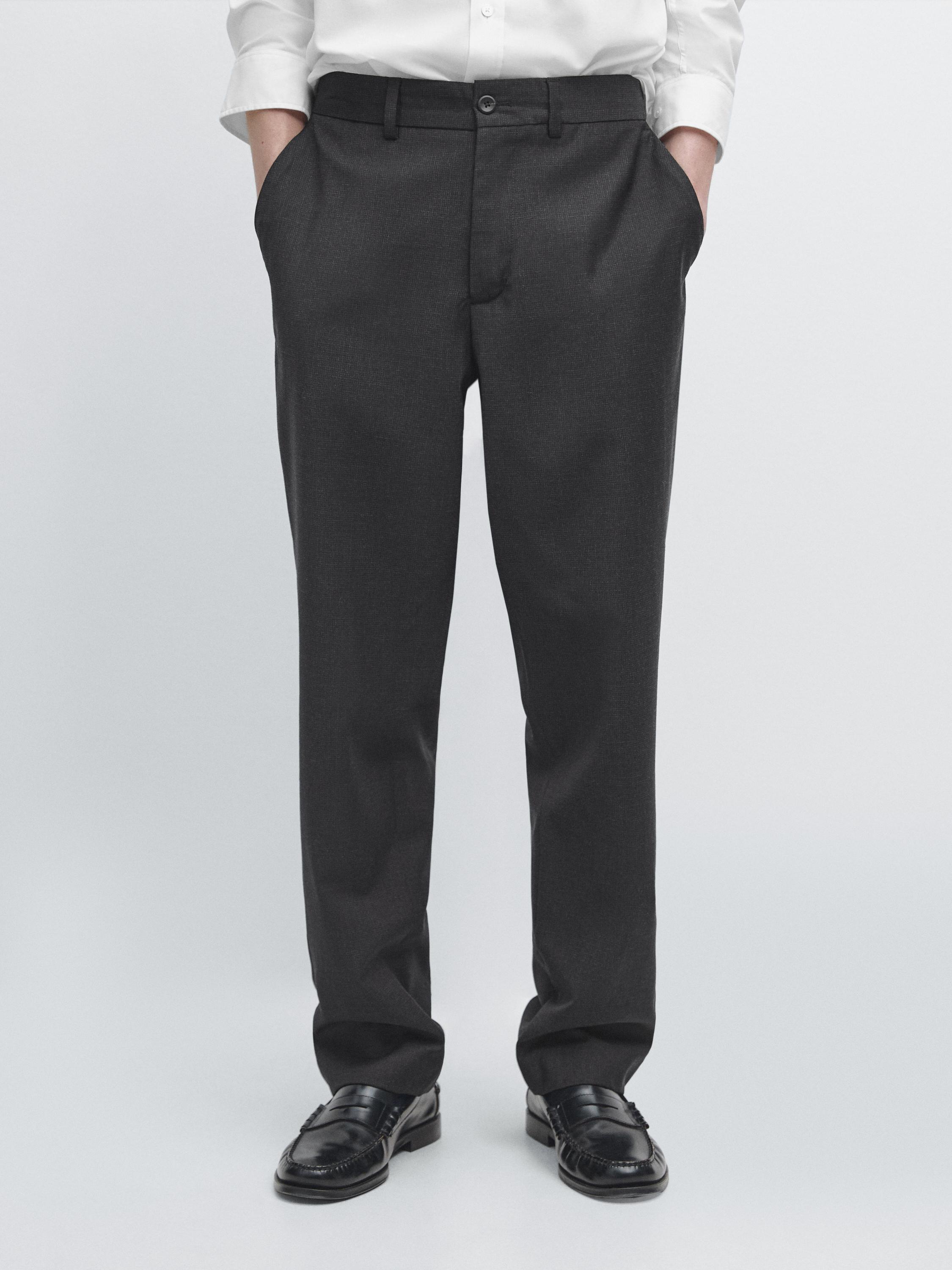 Navy blue pants set with side pockets and button closure, paired with a white shirt.