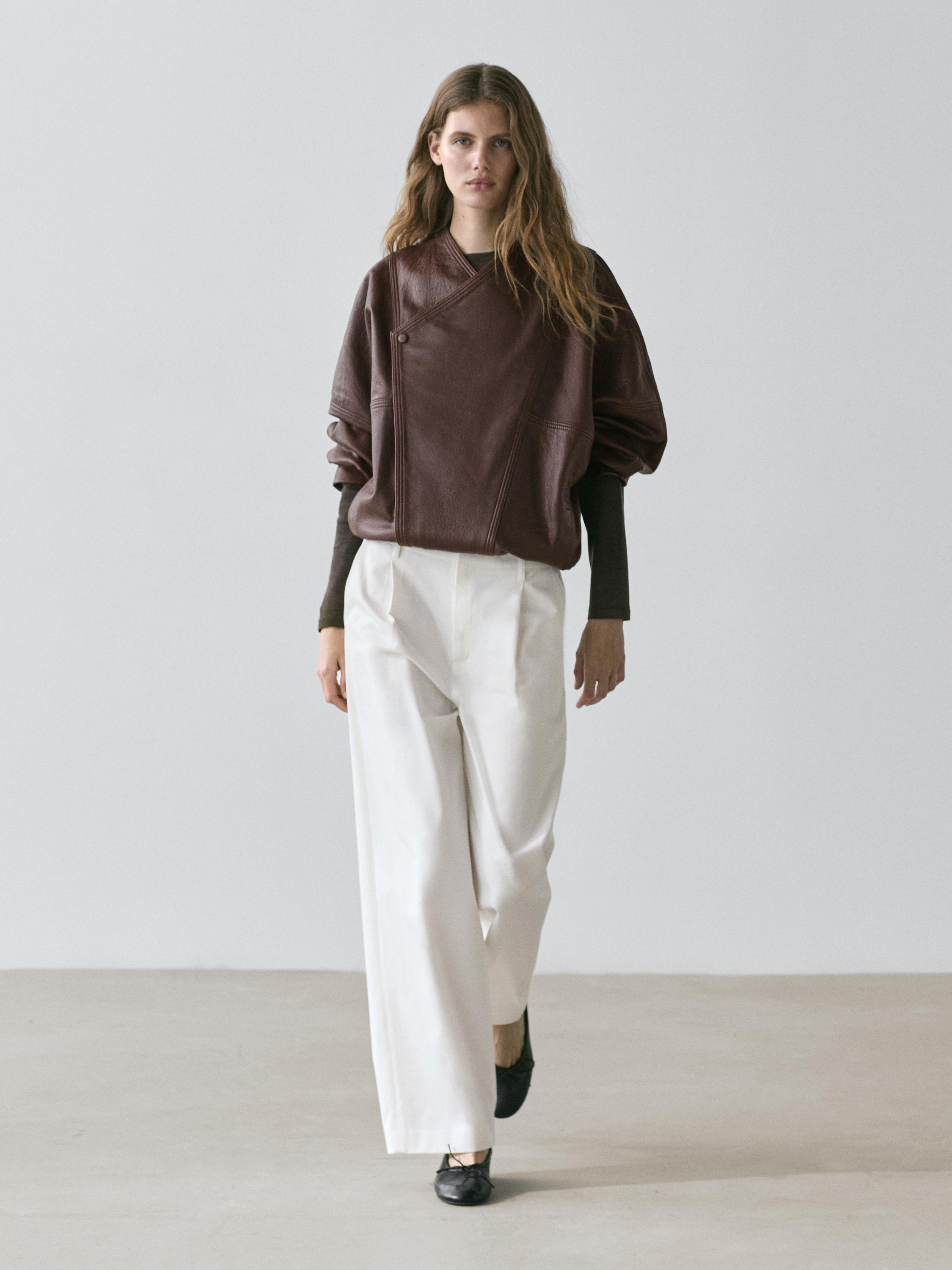 Brown double-breasted jacket and white pleated pants with black shoes set.