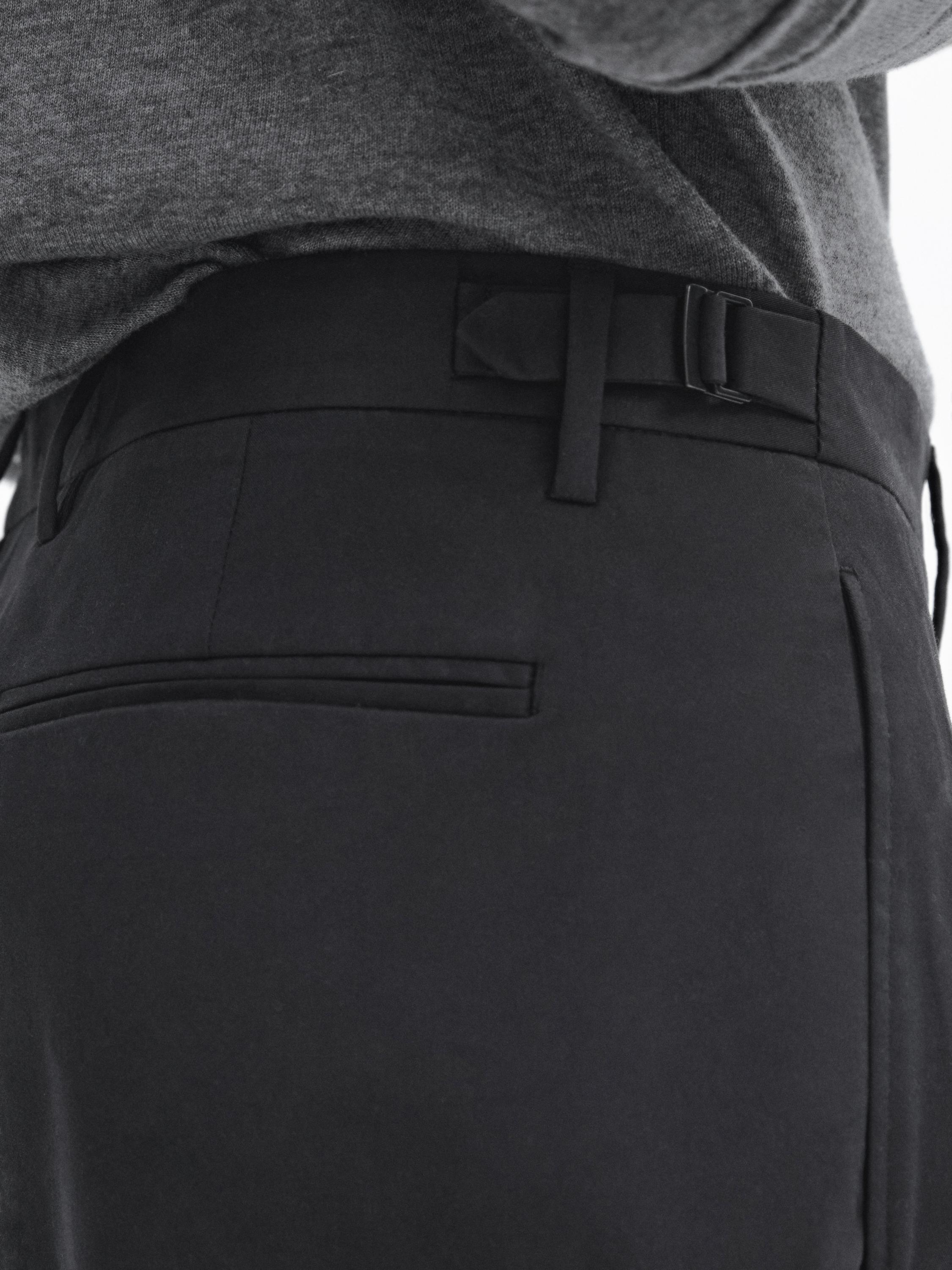 Tapered fit trousers with buckle detail