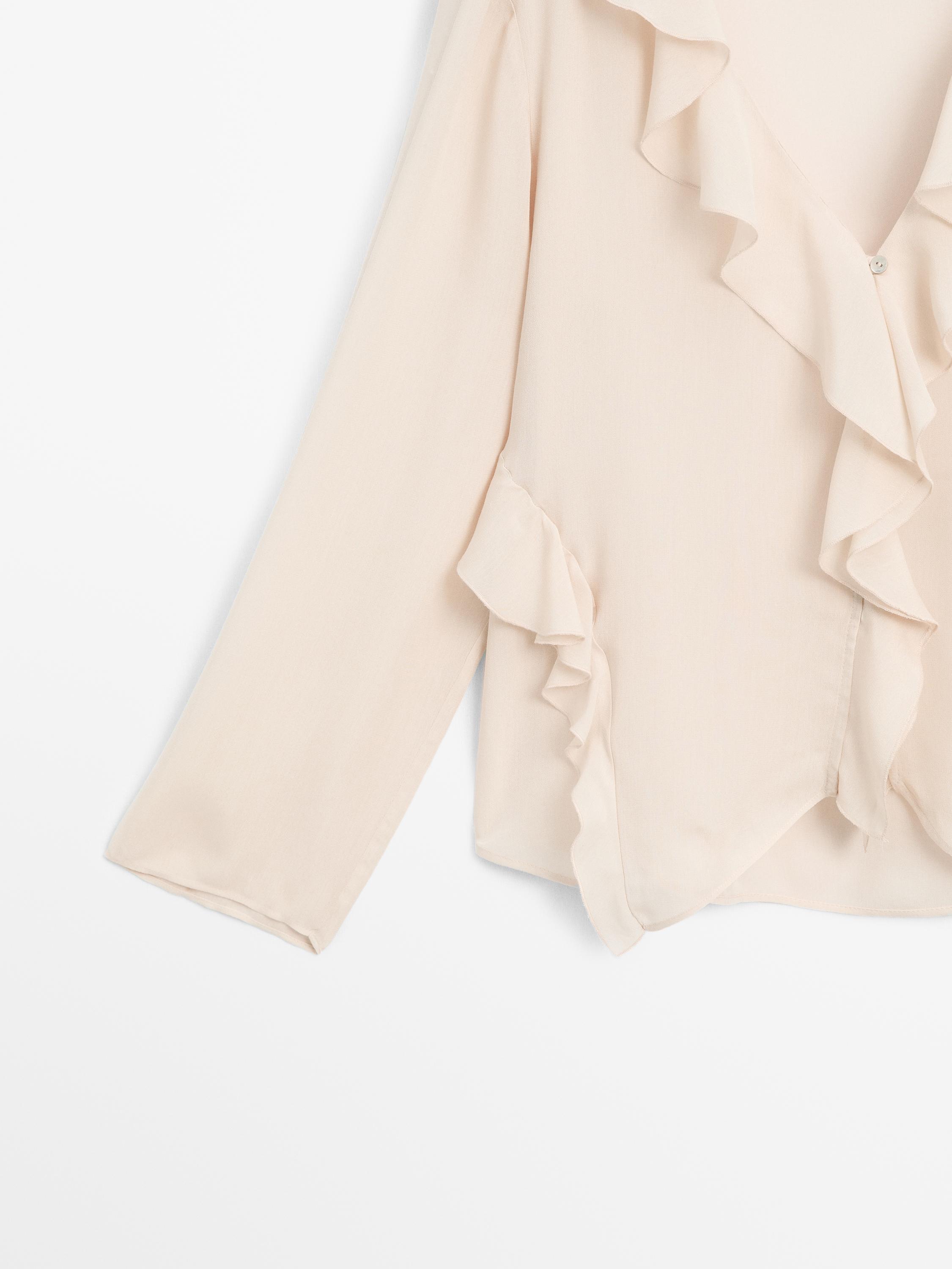 Ruffled blouse with asymmetric hem