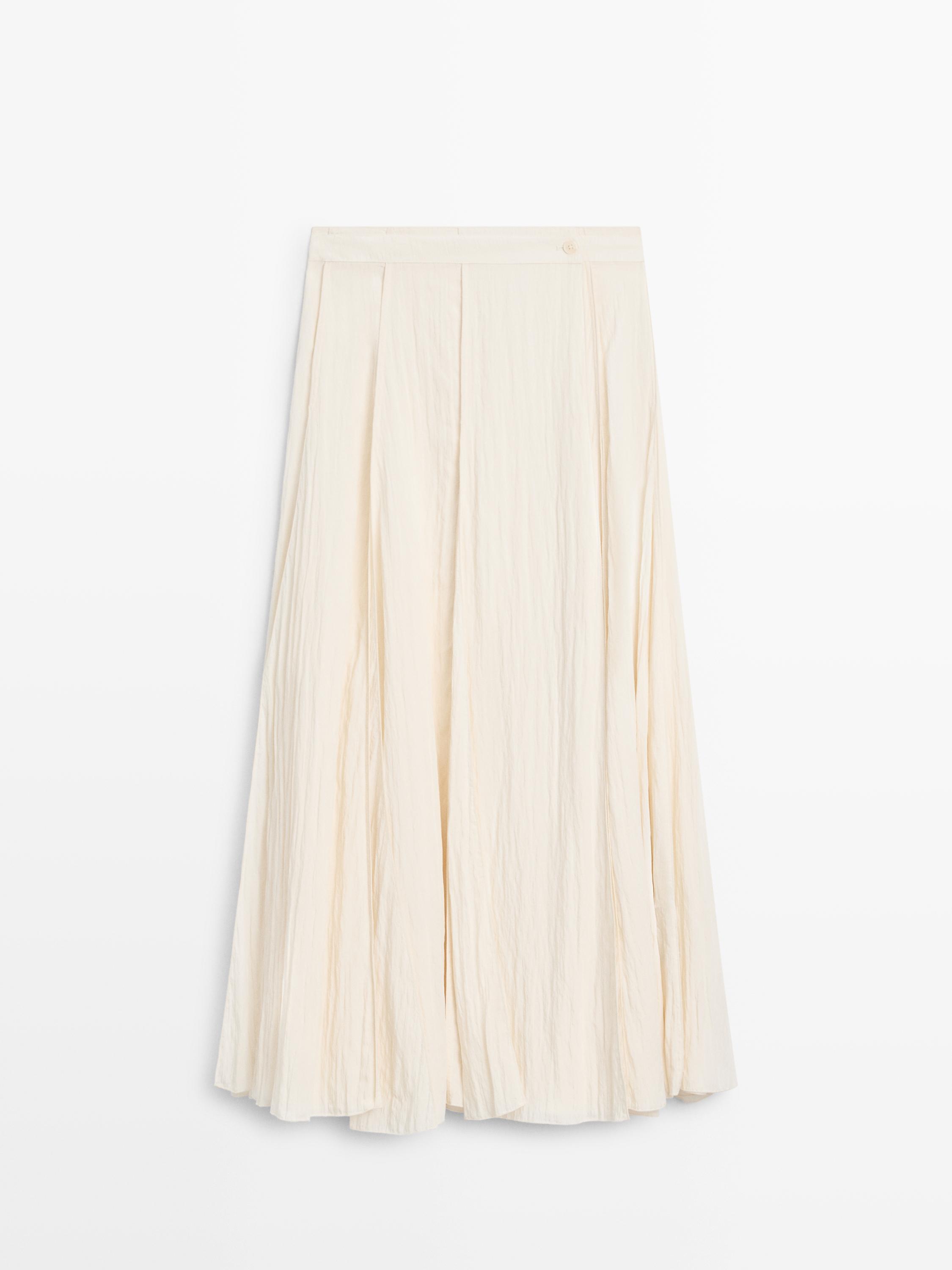 Front view of beige midi skirt with sash detail and pleats.