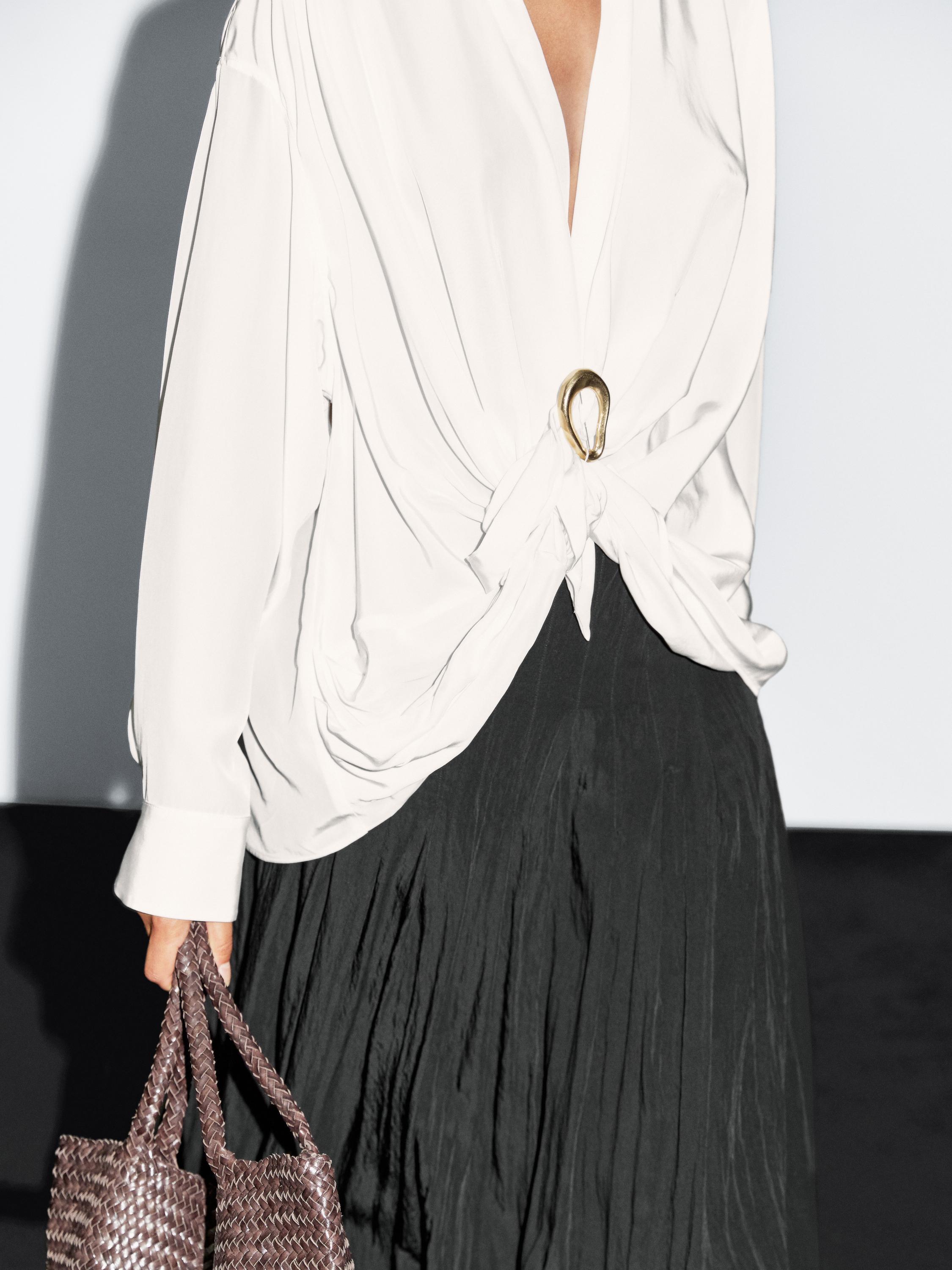 Blouse with knotted neckline and brooch detail