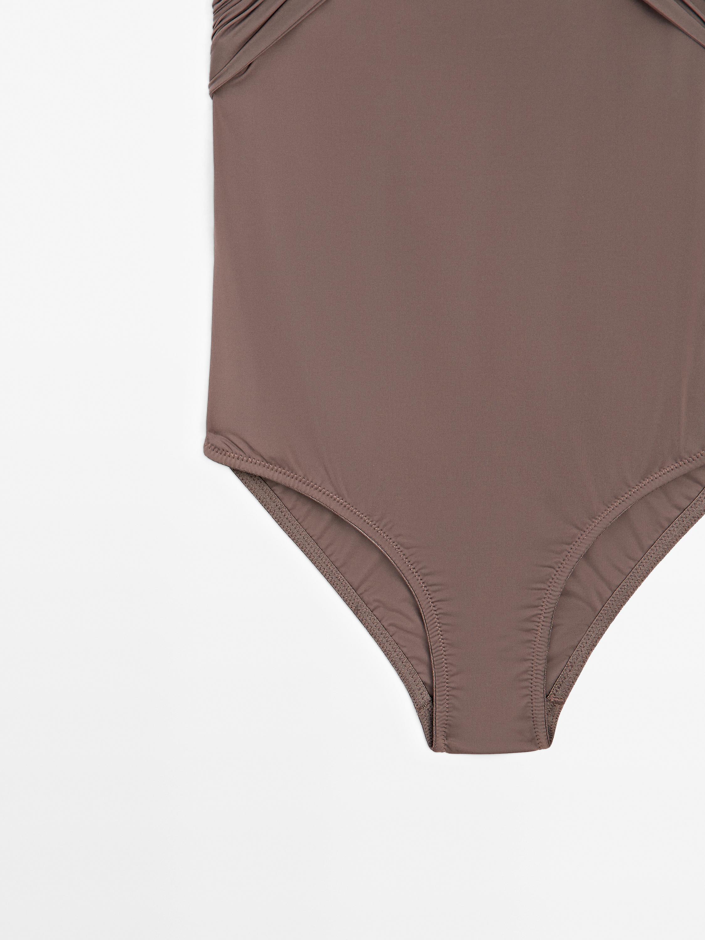 Bandeau swimsuit with criss-cross straps
