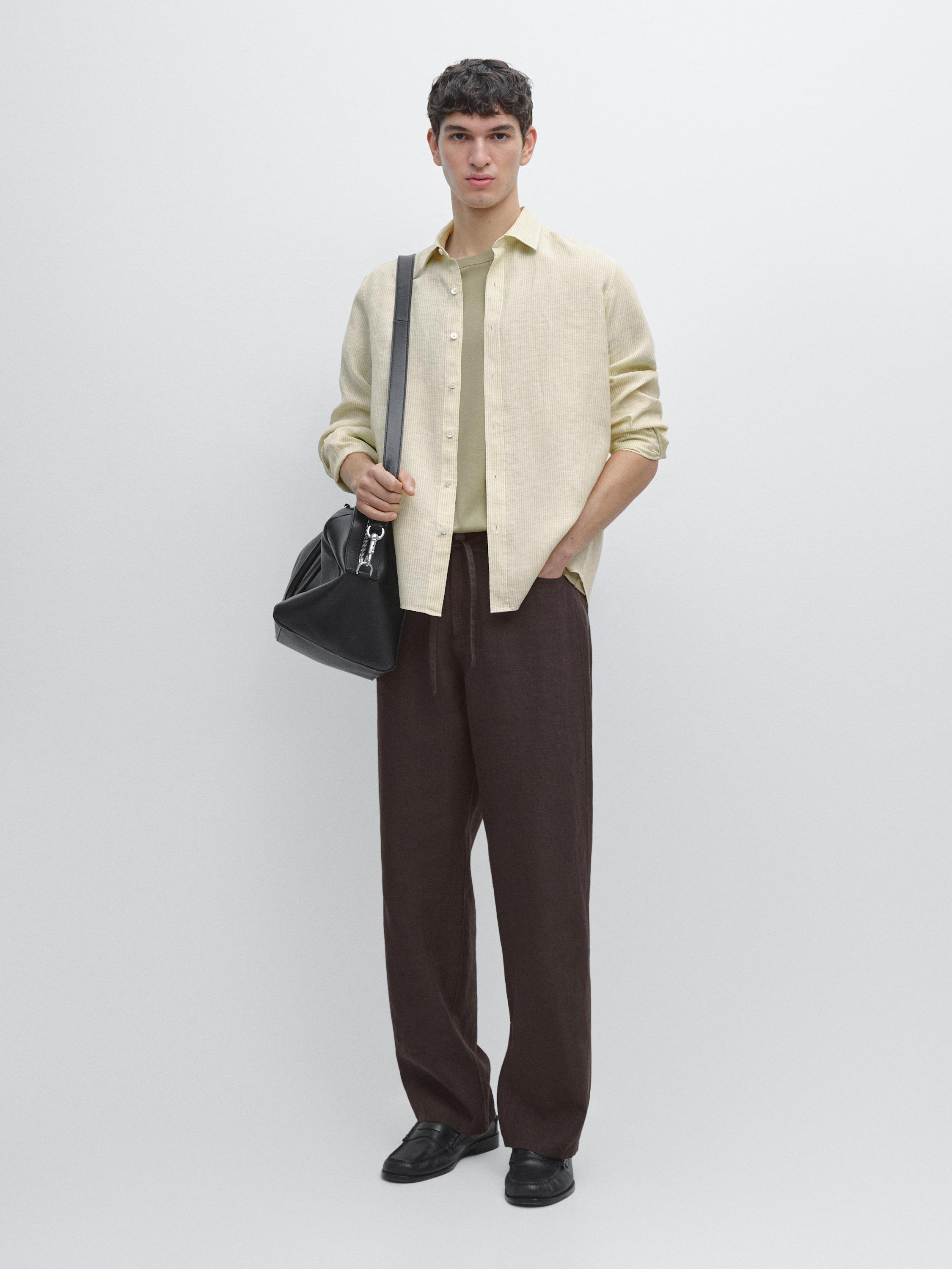 Beige button-up shirt set, light green t-shirt, and brown pants. Side pocket visible on the pants.