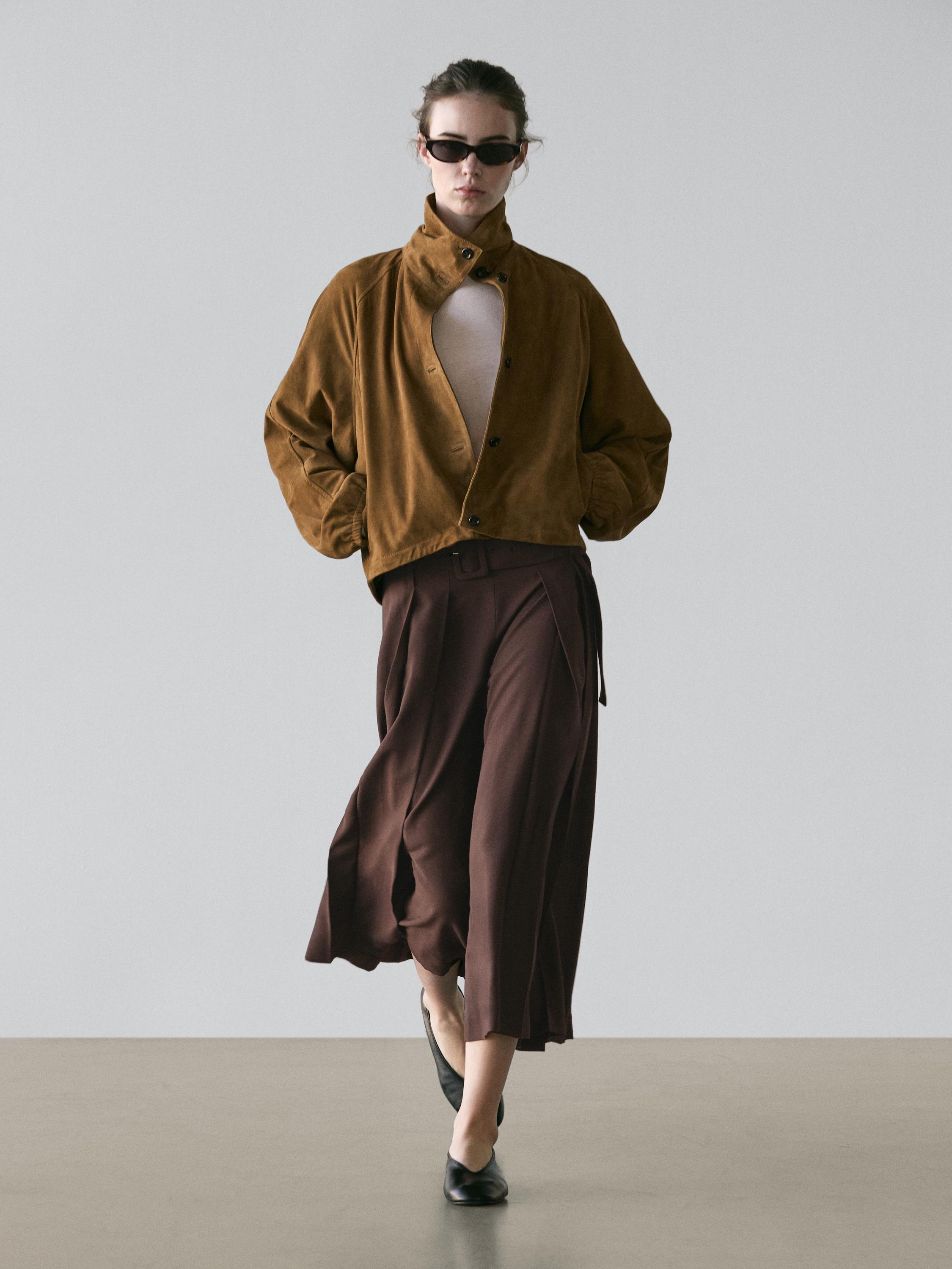 Brown button-up jacket and brown pleated midi skort set.