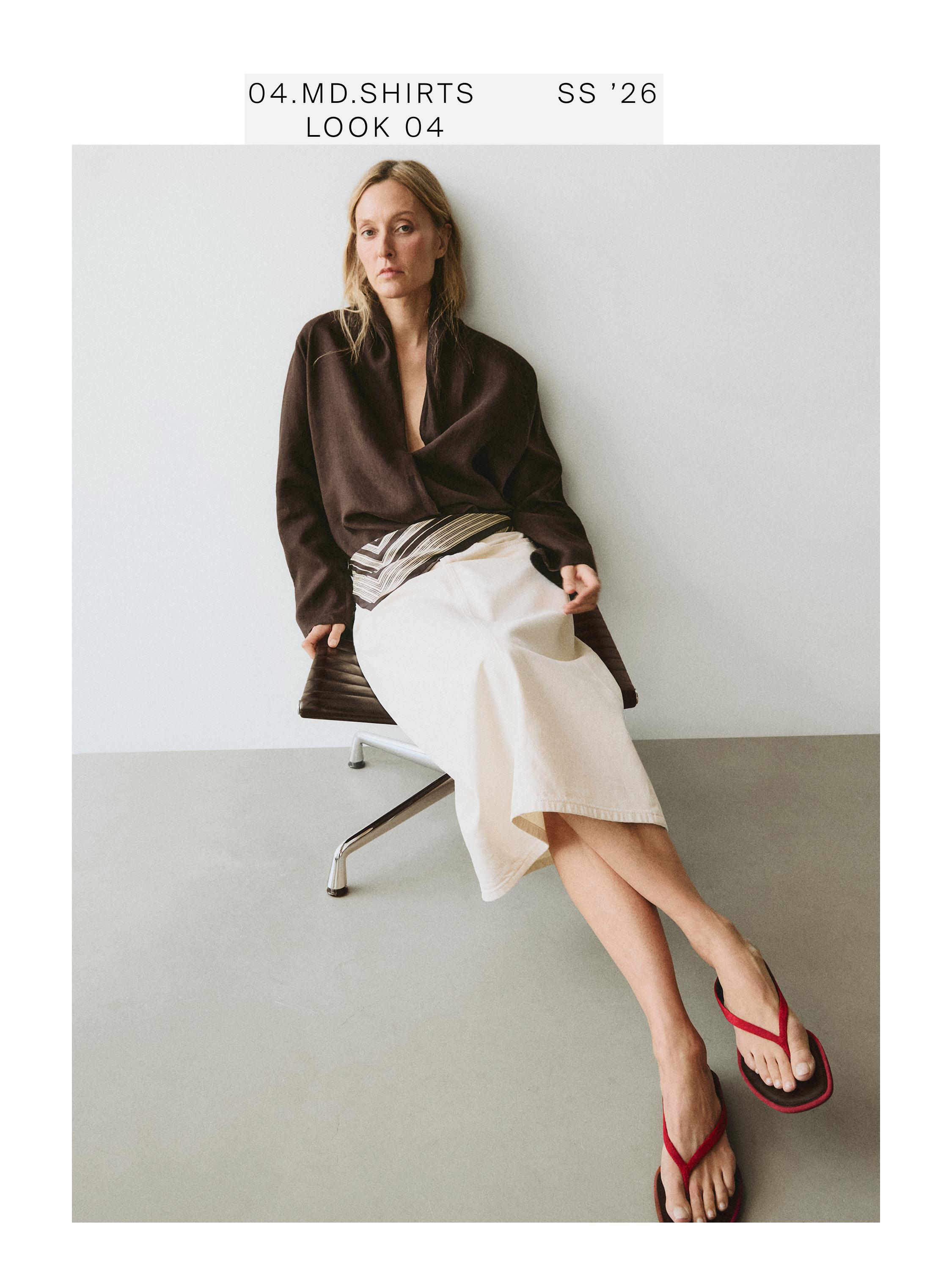 Brown wrap blouse and long beige skirt set. Visible text: "04.MD.SHIRTS SS '26 LOOK 04".