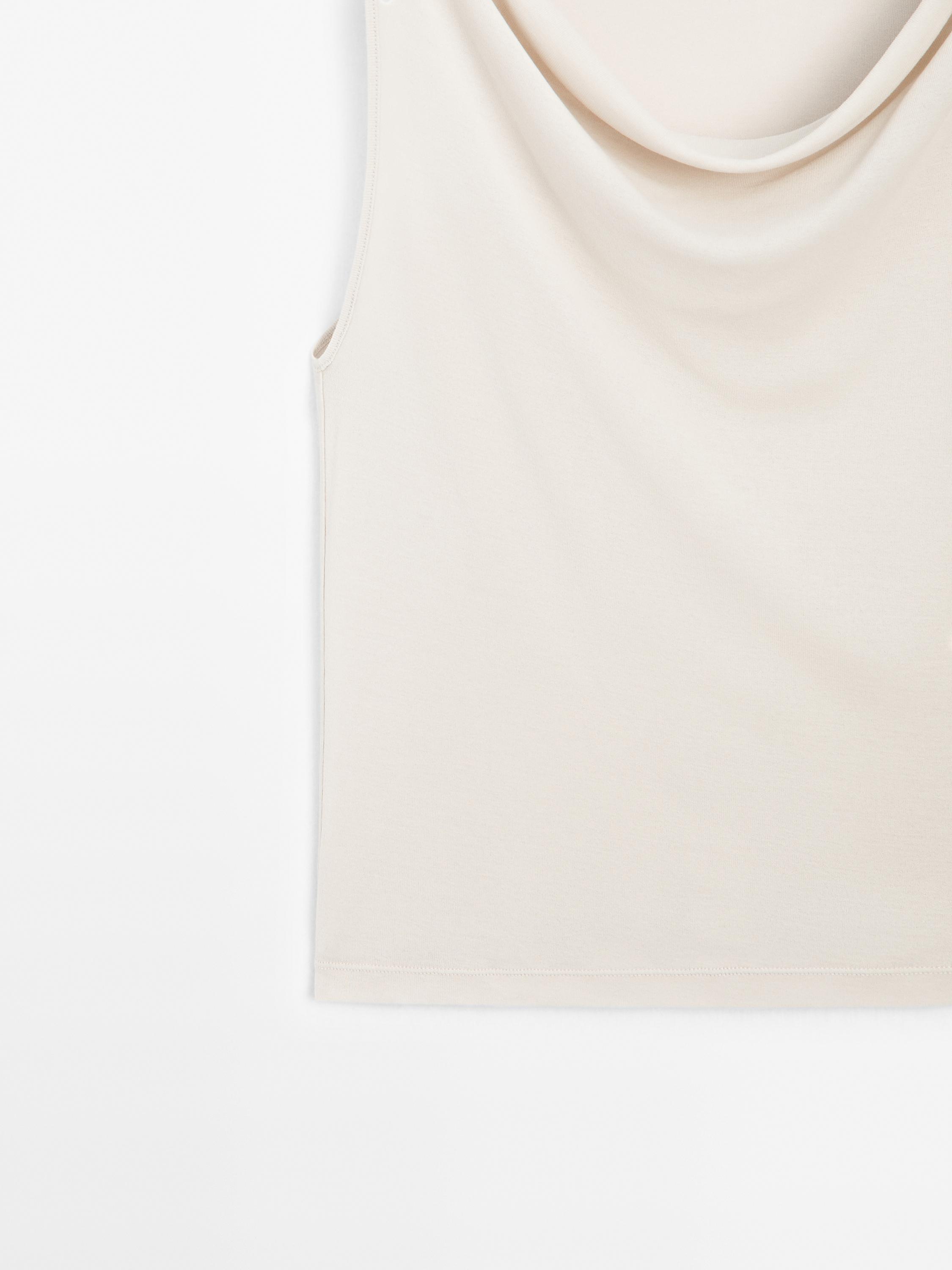 Sleeveless top with draped neckline