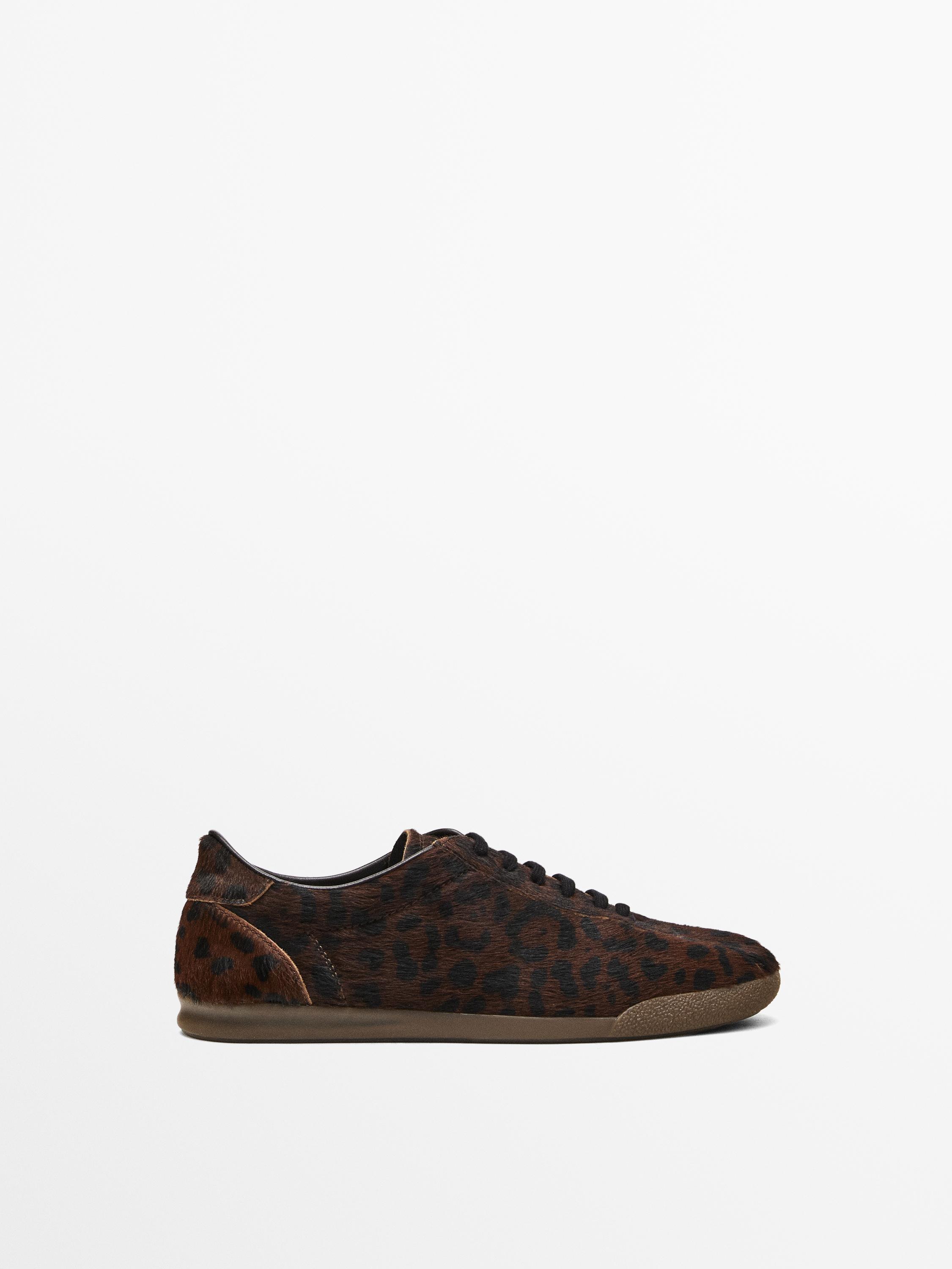 Leopard print hair on leather trainers