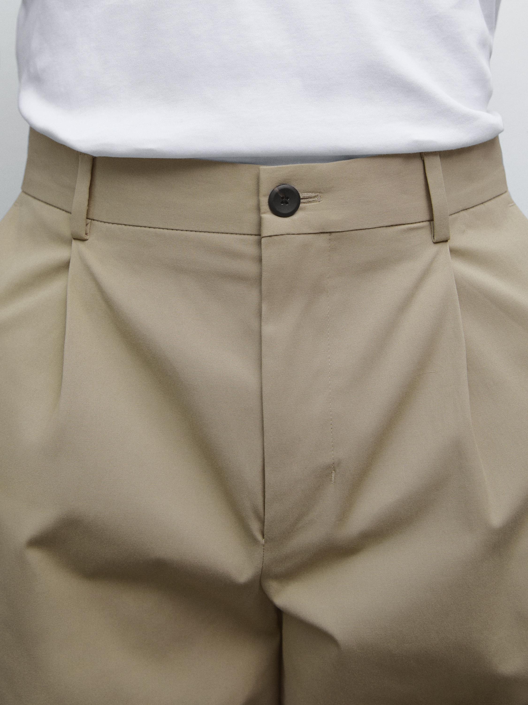 Брюки свободного кроя с защипами