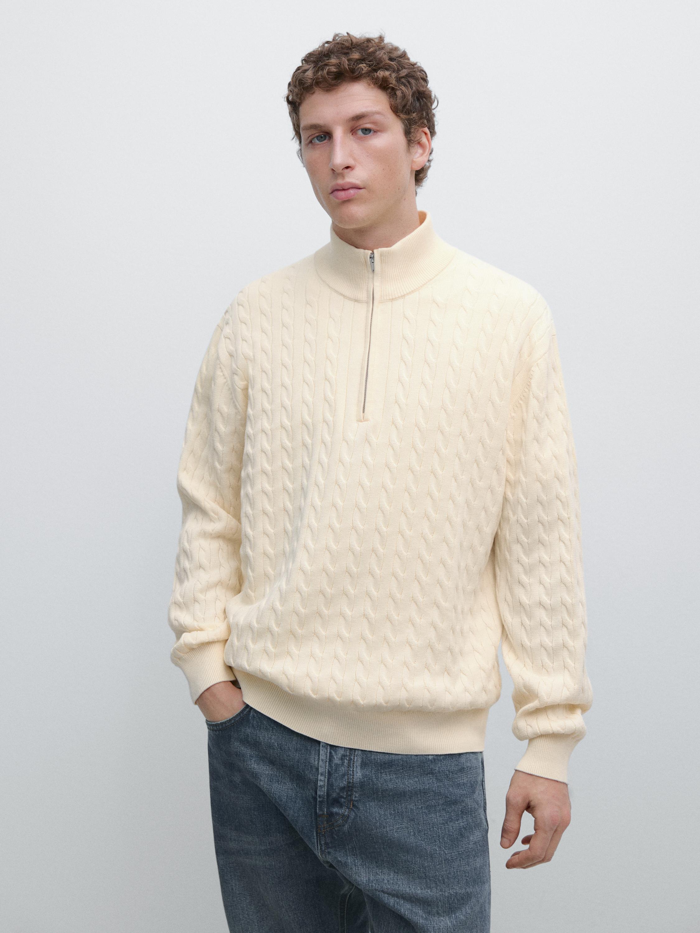 Ecru knitted sweater set with mock neck and zipper, braided design, ribbed cuffs and hem.