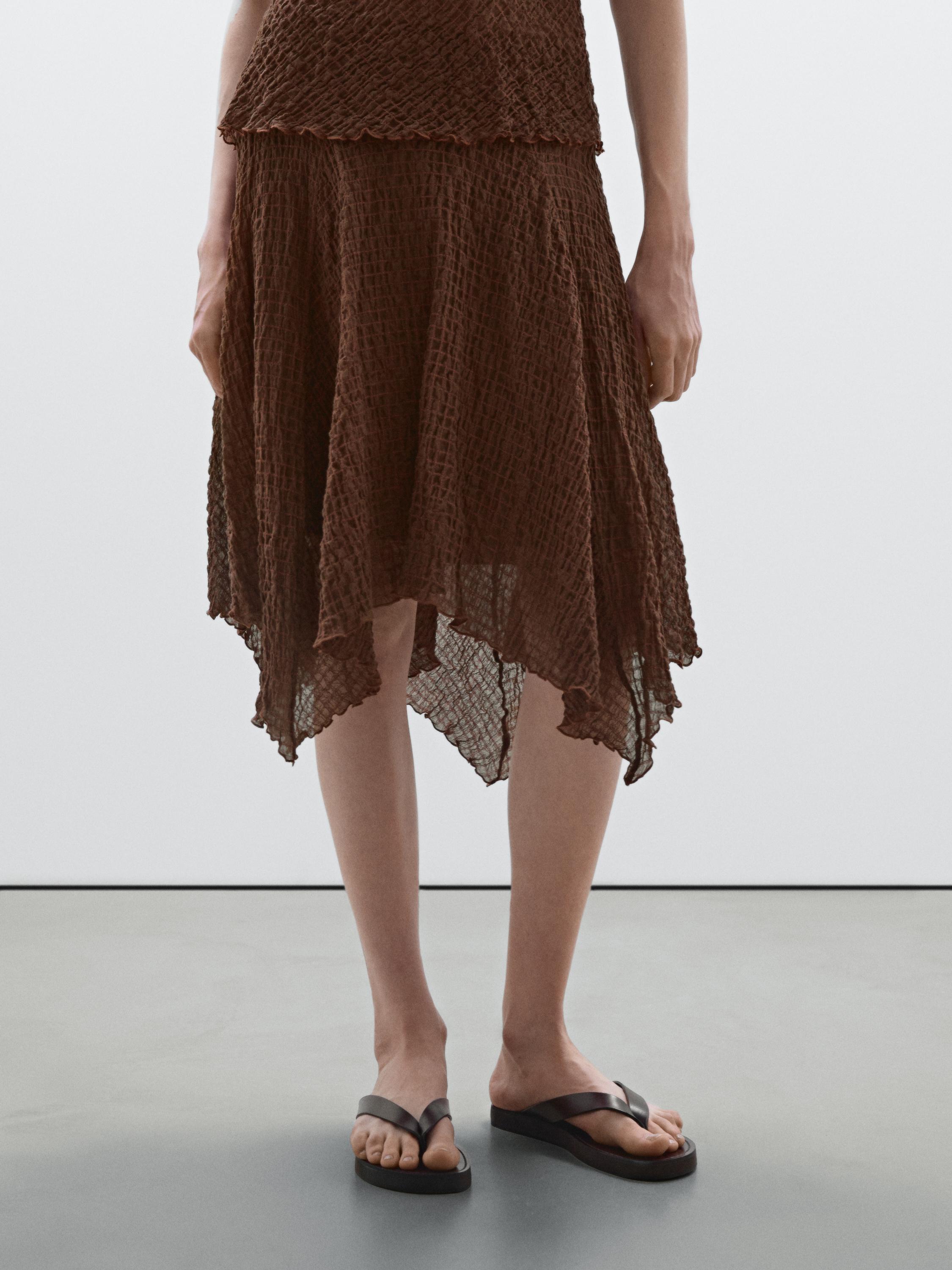 Flowing check skirt with asymmetric hem