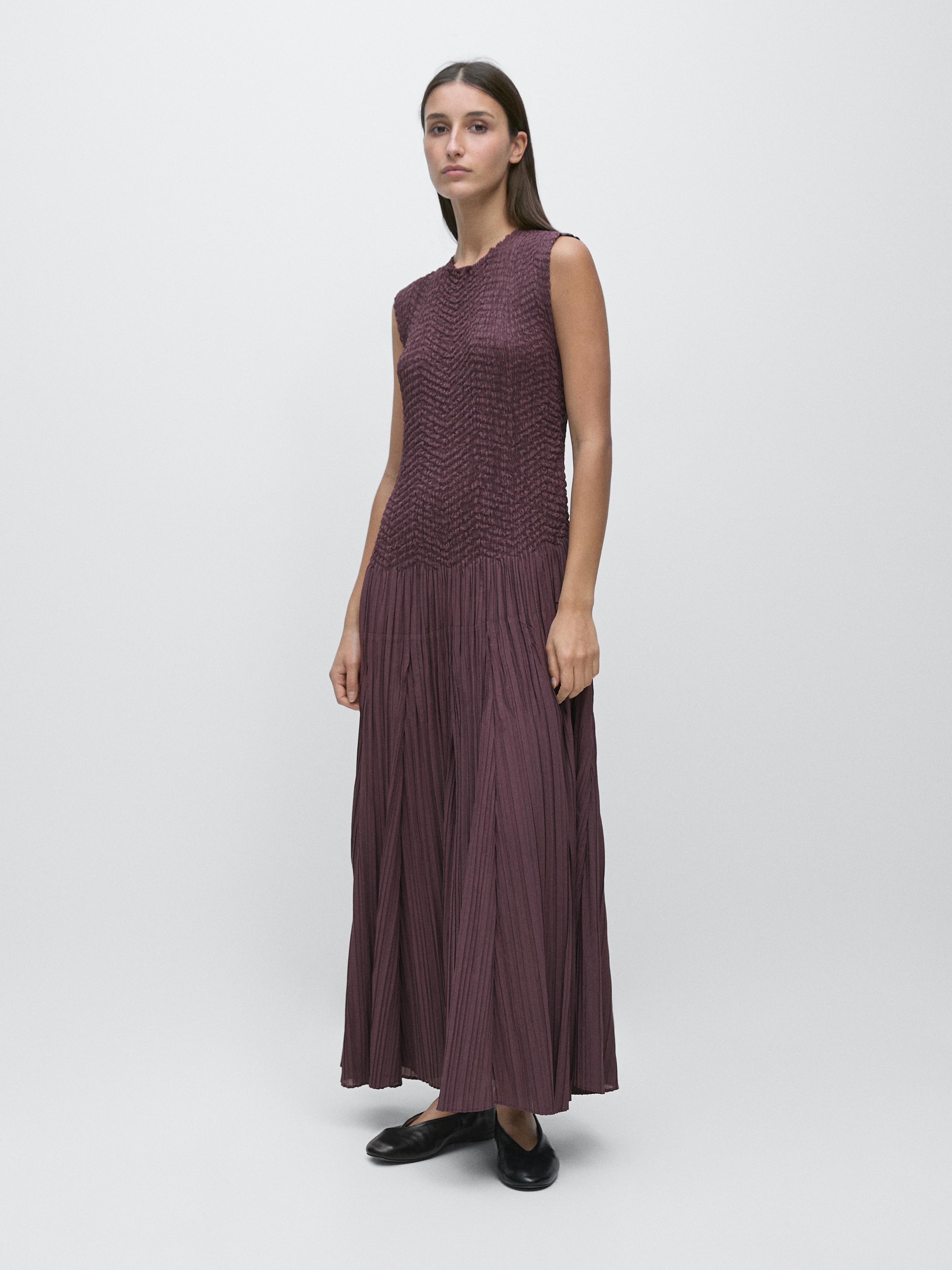 Sleeveless eggplant-colored pleated long dress set.