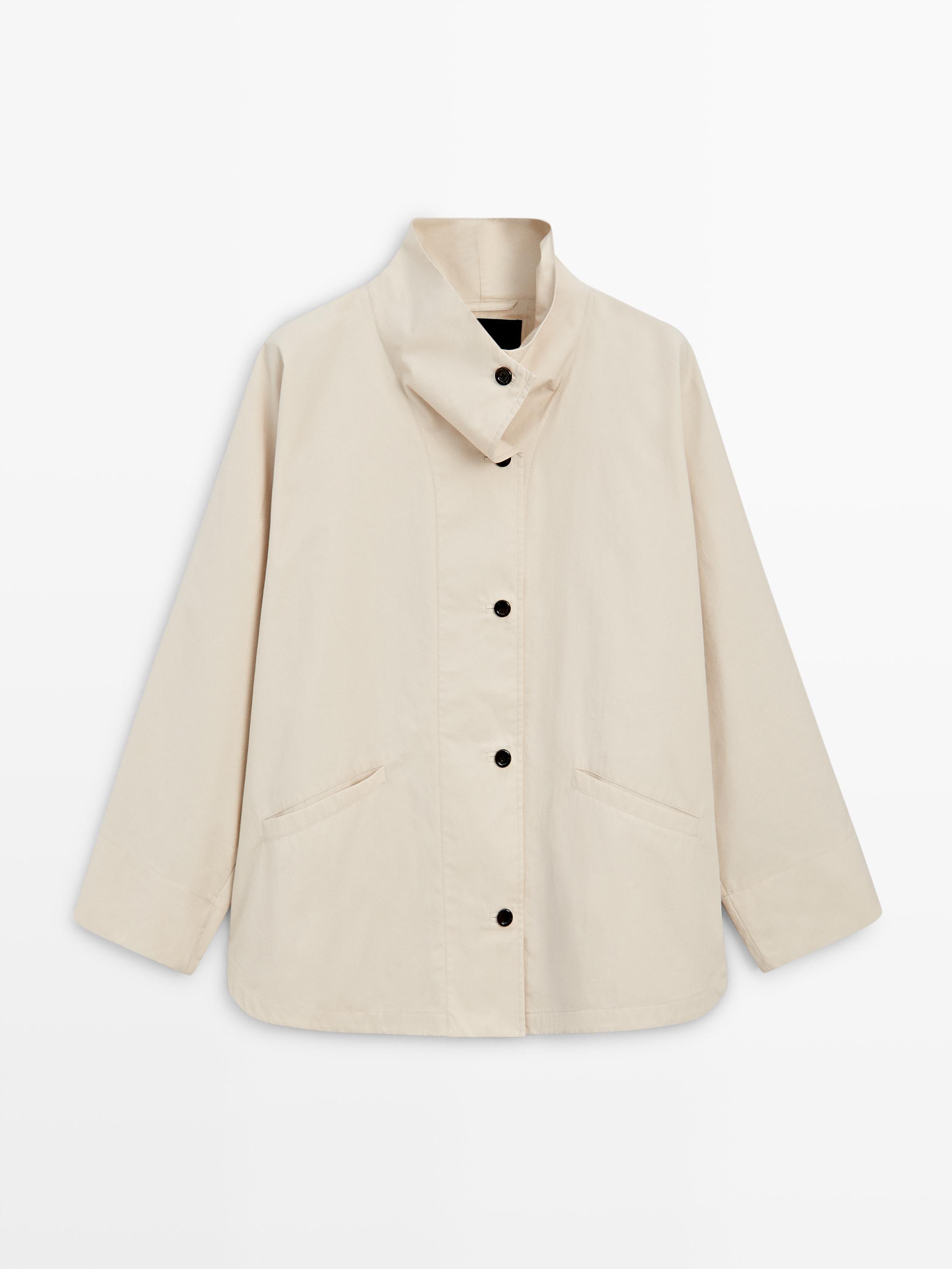 Front view of an jacket with a raised collar, black buttons, and side pockets.